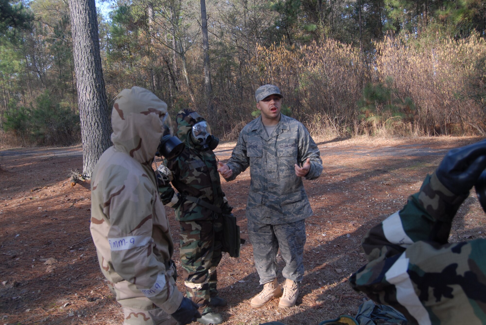 Staff Sgt. Richard Brown, 43rd Civil Engineer Squadron, instructs on how to properly wear mission-oriented prevention postures gear during Ability to Survive and Operate Training here Feb. 7. (U.S. Air Force Photo by 2nd Lt. Chris Hoyler)