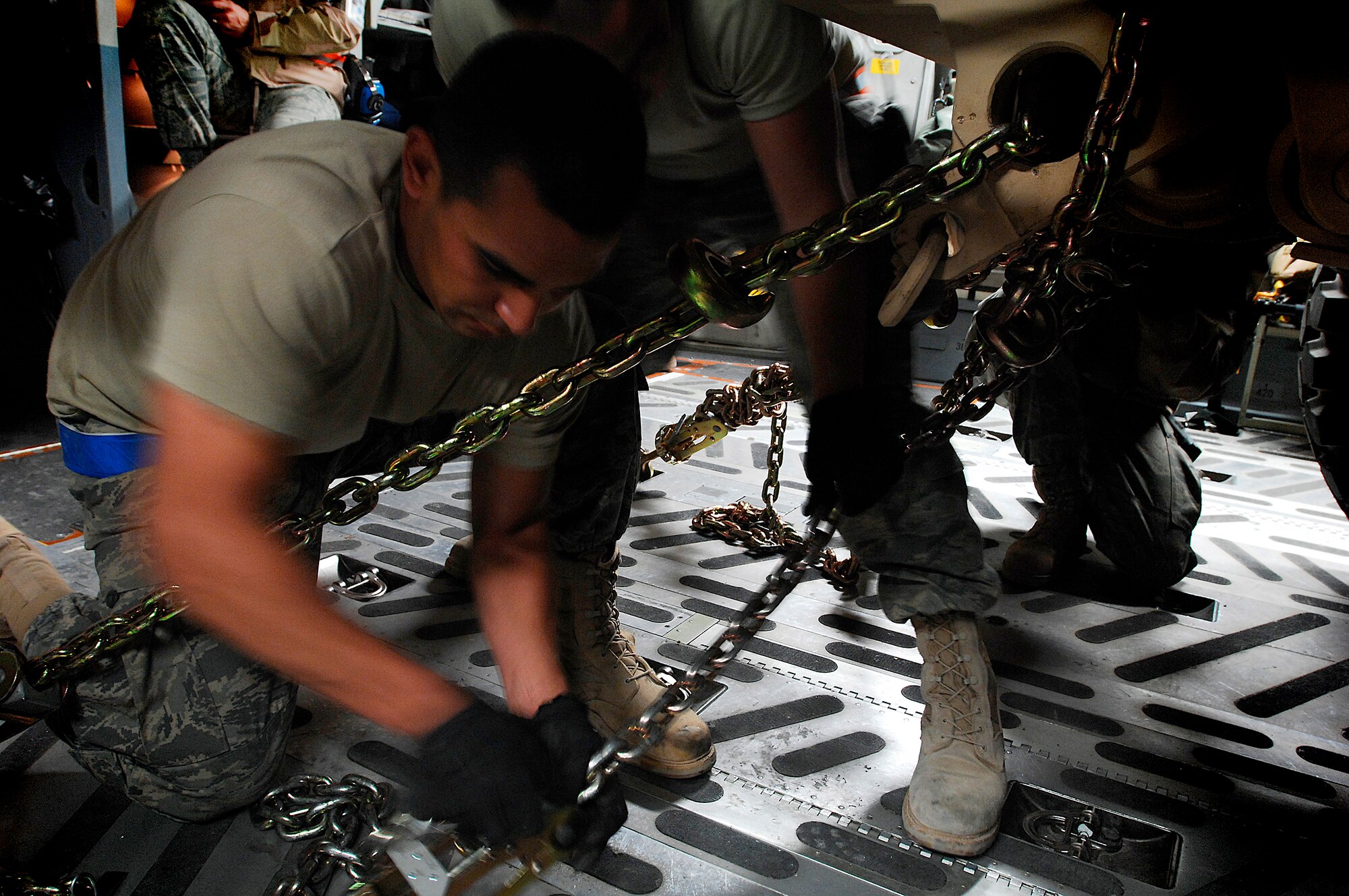 SOUTHWEST ASIA -- Senior Airman Joseph Lopez, an air transportation journeyman from 386th Expeditionary Logistics Readiness Squadron, secures a Mine Resistant Ambush Protected vehicle to the flooring of a Globemaster III cargo bay at a Southwest Asia air base Feb. 8, 2008. The MRAP vehicles are a family of armored fighting vehicles designed to survive various types of improvised explosive device attacks and ambushes. These MRAP vehicles are being delivered to the Marine Corps throughout the area of responsibility in support of Operation Iraqi Freedom.  (U.S. Air Force photo/ Staff Sergeant Patrick Dixon)