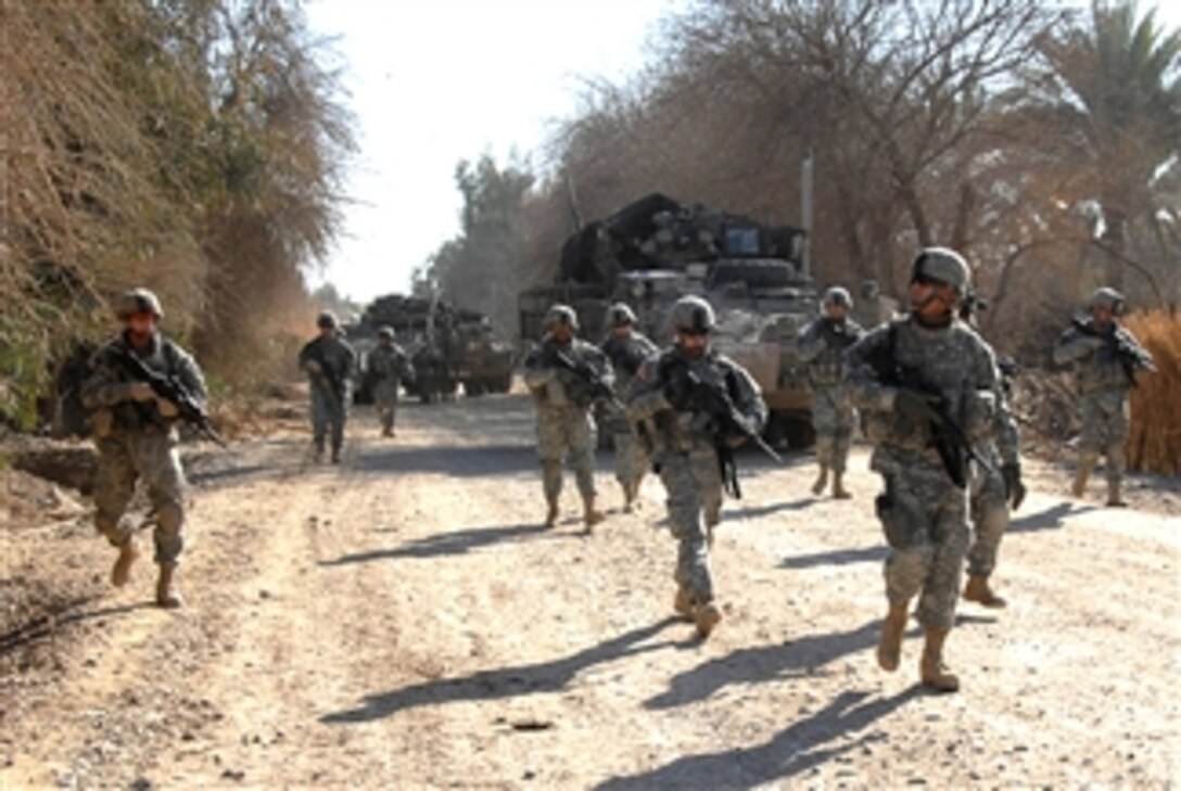 U.S. Army Brig. Gen. James Boozer, right, scans the area during a patrol with his protective security detail in Muqdadiyah, Iraq, Feb. 5, 2008. 