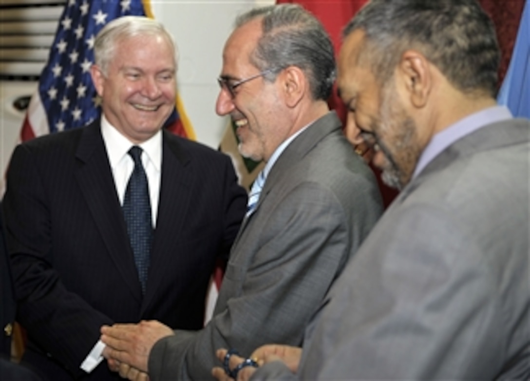 U.S. Defense Secretary Robert M. Gates, left, and Iraqi National Security Advisor Mouwaffak al-Rubaie, center, talk with one another during Gates' unannounced visit to Iraq, Feb. 10, 2008.  