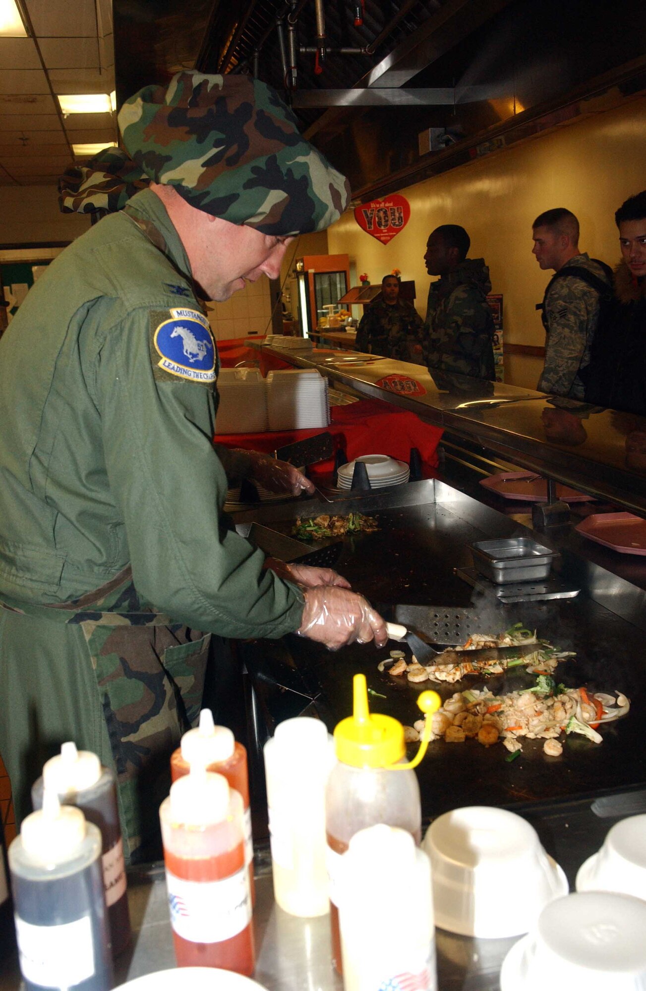 Col. Jon Norman, 51st Fighter Wing commander, grills Mongolian barbecue Feb. 12 at the Pacific House Dining Facility during the 51st Services Squadron’s “Feeding the Force” Mongolian barbecue meal, a monthly event designed to increase morale and customer satisfaction. (U.S. Air Force photo/Staff Sgt. Candy Knight)