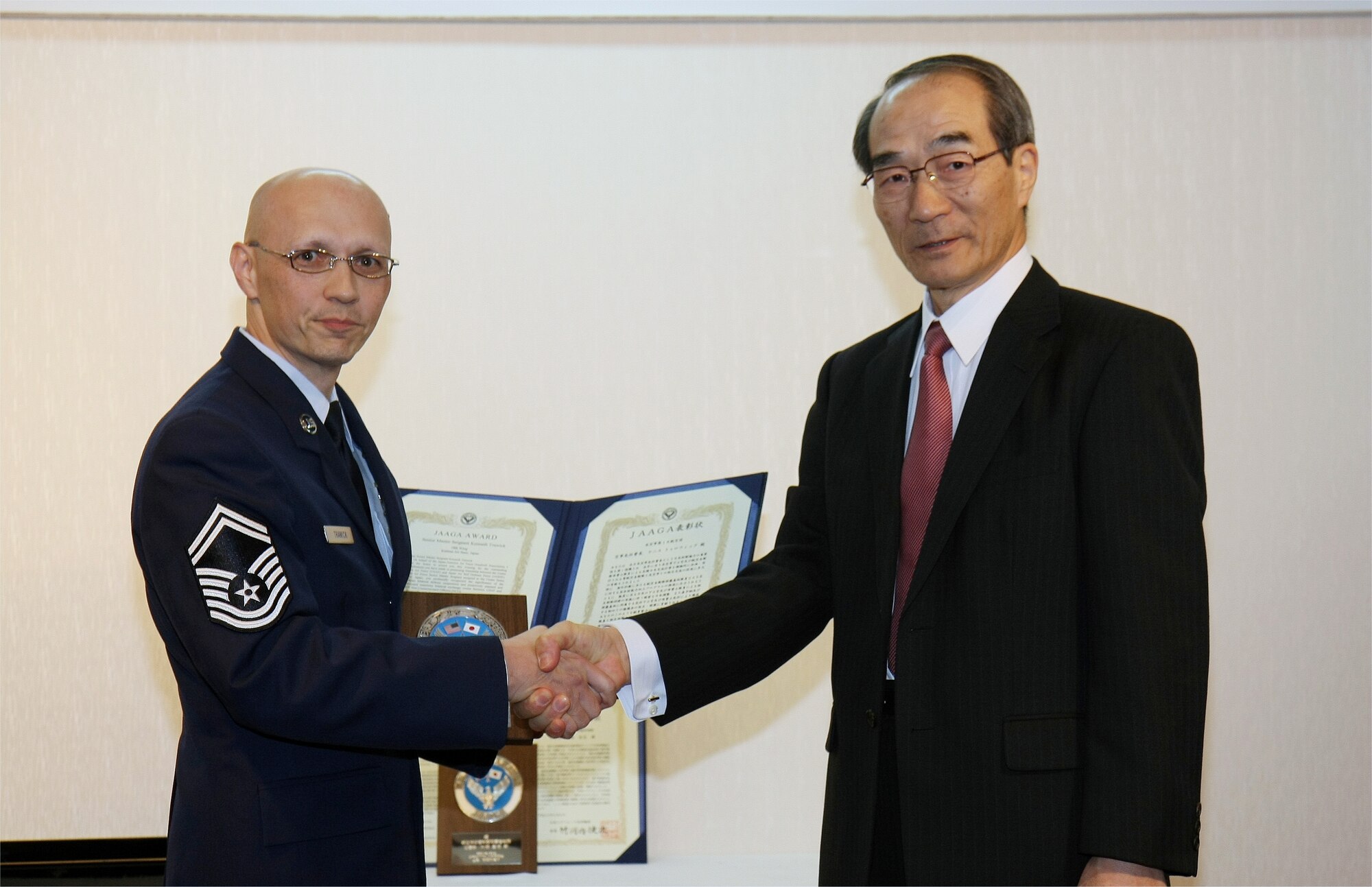 Senior Master Sgt. Kenneth Trawick, 18th Wing AFSO 21 process manager, was recognized in a ceremony Feb. 8 by the Japan-American Air Force Goodwill Association for his efforts setting up exchange programs between Kadena and Japanese Air Self Defense Force Airmen. Retired JASDF Gen. Shoji Takegochi presided over the ceremony and presented Sergeant Trawick with the award, which consisted of a plaque and citation in both English and Japanese. He praised Sergeant Trawick's work to enhance camaraderie and teamwork between the two Air Forces. (Courtesy photo)