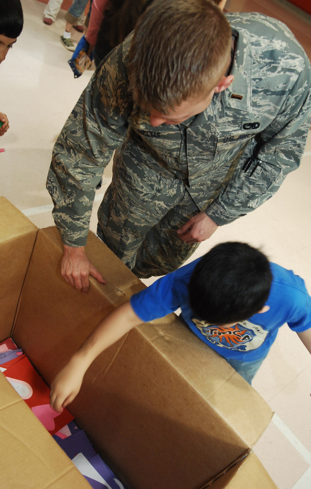 CANNON AIR FORCE BASE, N.M. -- 2nd Lt. Cory Helms, 27th Special Operations Component Maintenance Squadron, places Valentine cards inside a box at Mesa Elementary School on Feb. 08, 2008.  Lt. Helms, volunteered his time helping third graders make valentine cards for deployed military members.  (US Air Force photo by Airman 1st Class Evelyn Chavez)  (Released)  