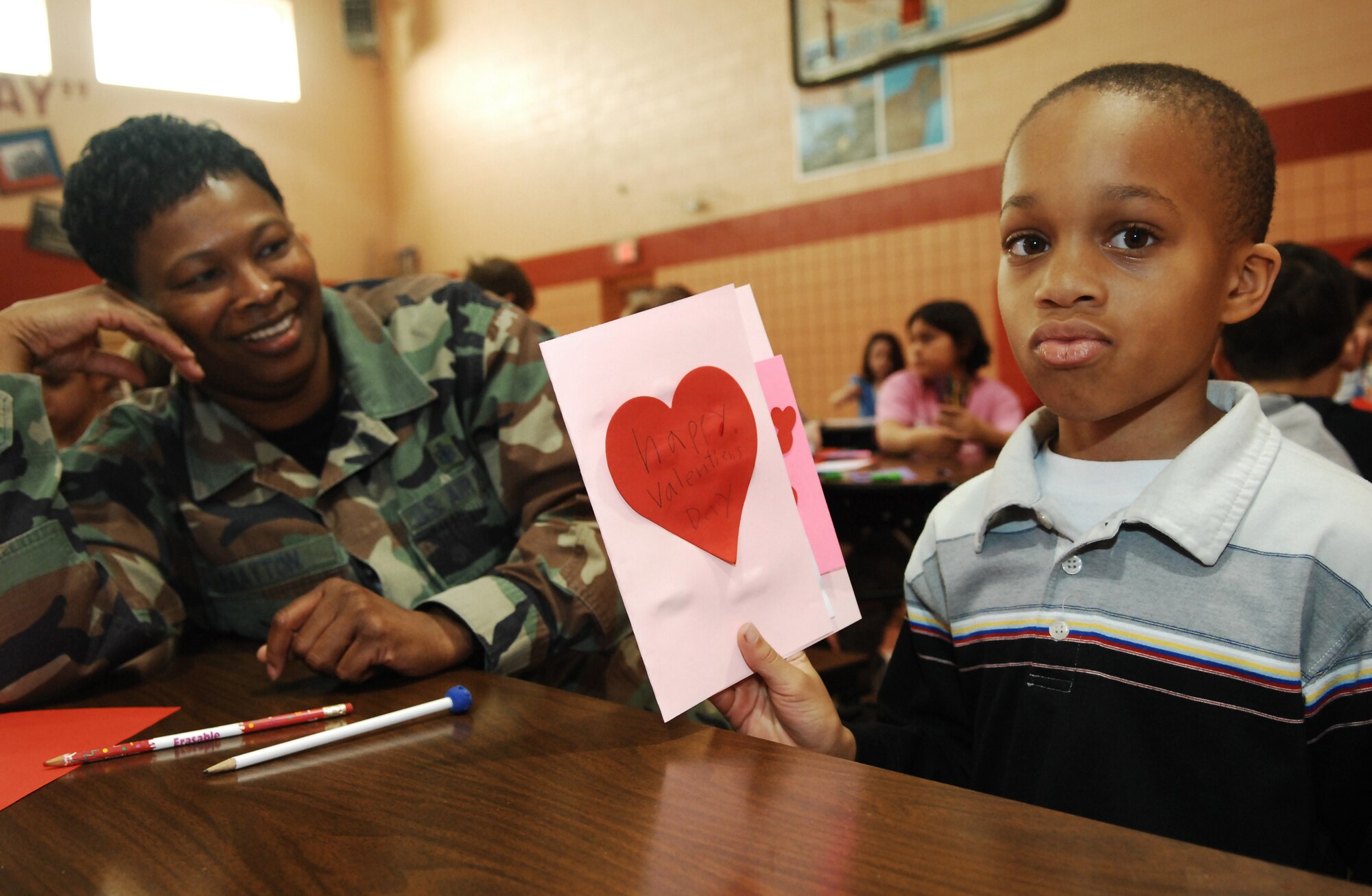 CANNON AIR FORCE BASE, N.M. -- Jalel, a 3rd grade student from the Mesa Elementary School in Clovis, N.M. display a Valentine card he made with the help of Staff Sgt. Sherron Brayton, 27th Special Operations Medical Group, on Feb. 8.  The children will send Valentine cards to deployed military members to thank them for their service.  (US Air Force photo by Airman 1st Class Liliana Moreno)  