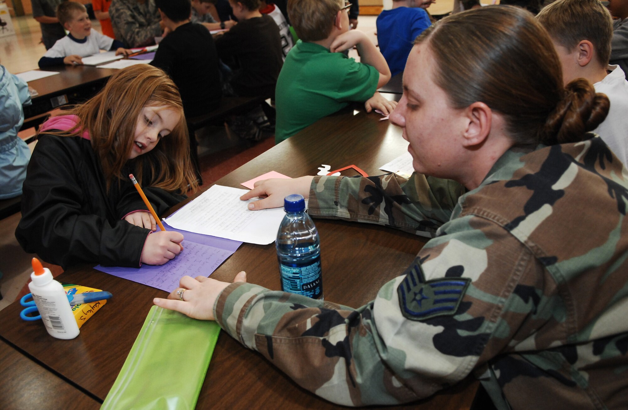 CANNON AIR FORCE BASE, N.M. -- Staff Sgt. Brandi Grove, 27th Special Operations Maintenance Group, helps Kaley, a 3rd grade student from the Mesa Elementary School in Clovis, make a Valentine card on Feb. 08, 2008. Staff Sgt. Grove, volunteered to help students make Valentine cards for deployed military members as part of the Company Grade Officer Club project.  (US Air Force photo by Airman 1st Class Liliana Moreno)   