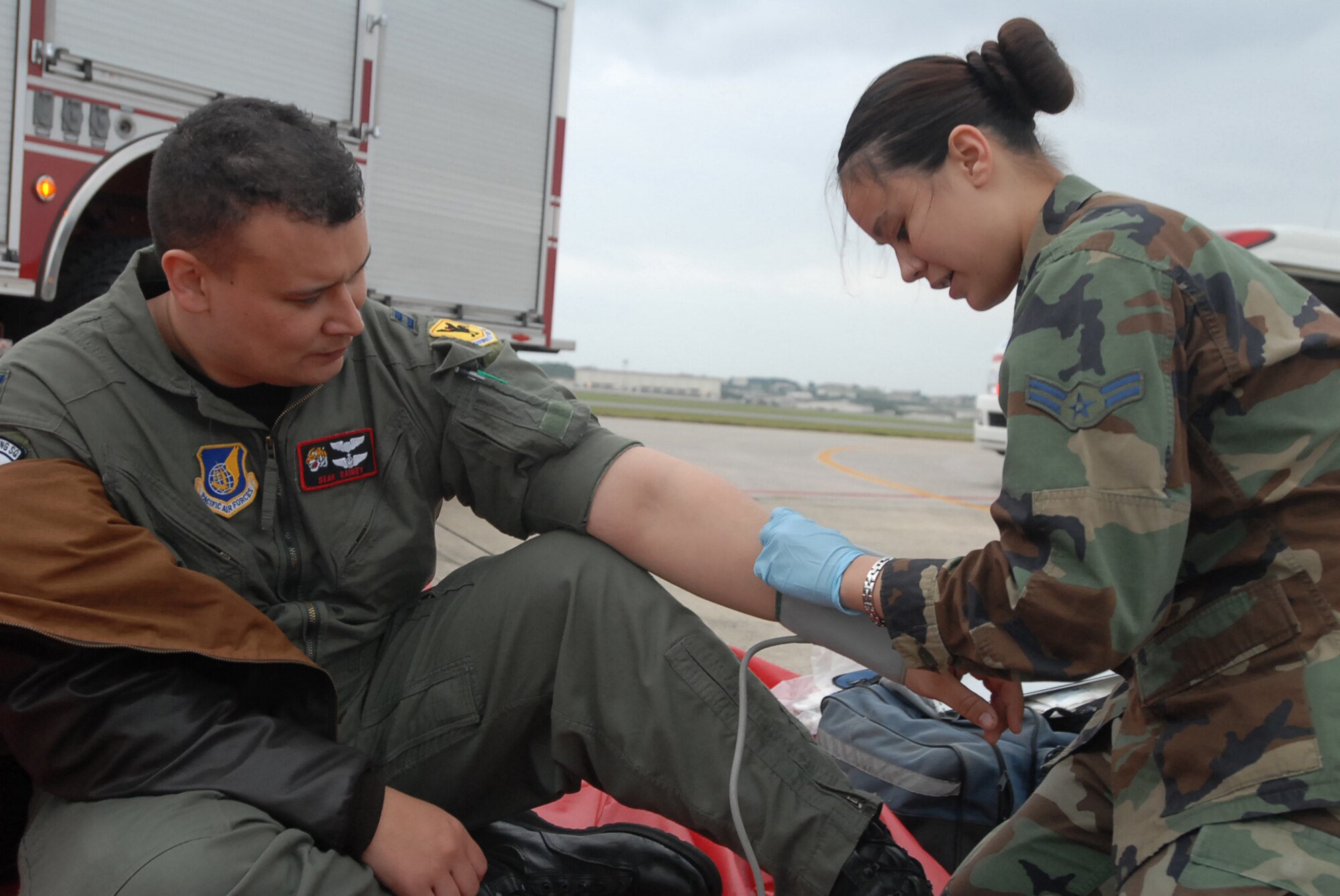 Airman 1st Class Tabatha Loomis, 18th Air Medical  Squadron, checks the blood pressure of injured Capt. Sean Rainey, 909th Air Rescue Squadron, during a KC-135 extraction scenario for local operational readiness exercise Beverly High 08-4 at Kadena Air Base, Japan, Feb. 12, 2008. The 18th Wing conducted the exercise from Feb. 10 to 15 to test Airmen's ability to respond in contingency situations. (U.S. Air Force photo/Senior Airman Darnell T. Cannady)