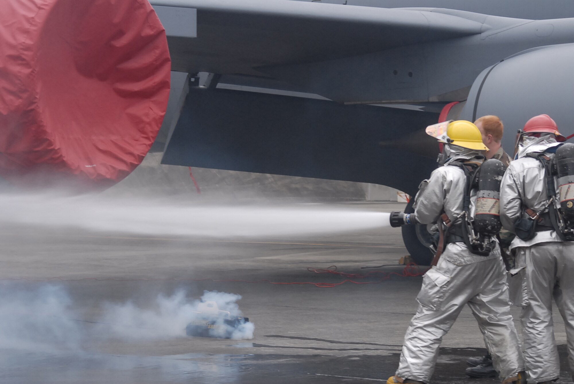 Fire fighters from the 18th Civil Engineer Squadron put out a simulated fire during local operational readiness exercise Beverly High 08-4 at Kadena Air Base, Japan, Feb. 12, 2008. The 18th Wing conducted the exercise from Feb. 10 to 15 to test Airmen's ability to respond in contingency situations. (U.S. Air Force photo/Senior Airman Darnell T. Cannady)