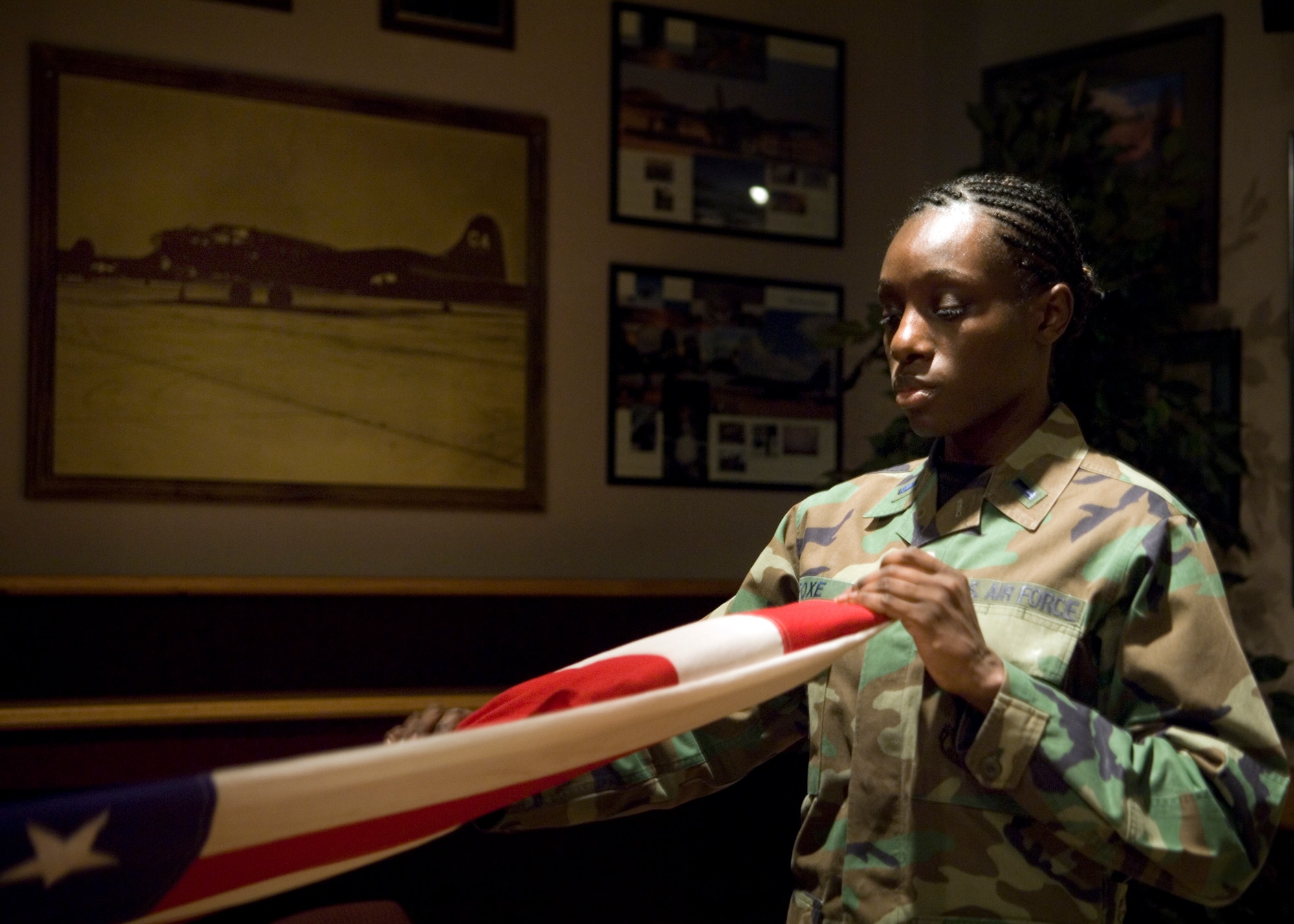FAIRCHILD AIR FORCE BASE, Wash. – 1st Lt. Lenora Foxe, 92nd Mission Support Group commander support staff flight chief, creases the colors during a flag-folding sequence at Club Fairchild. Team Fairchild honor guard members trained 92nd MSG officers on proper ceremonial flag-folding procedures Feb. 8. (U.S. Air Force photo / Airman 1st Class Joshua Chapman)