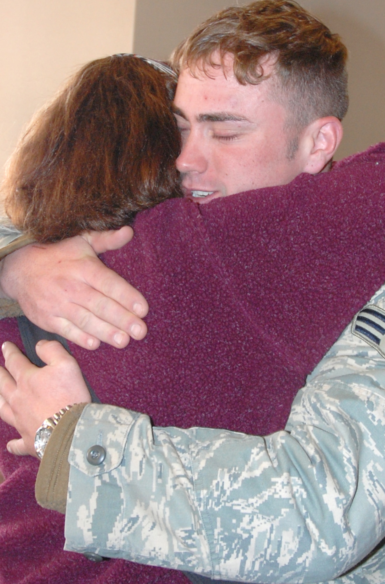 Airman 1st Class Michael Workmen, 21st Security Forces Squadron, embraces his mother Susan at the Colorado Springs Airport Feb. 12 after returning from a deployment to Camp Bucca, Iraq. Airman Workmen, a native of La Junta, Colo., re-deployed to Peterson with 10 other 21st SFS Airmen. The Airmen, deployed for six months, supported Operation Iraqi Freedom conducting ‘In Lieu Of” Army taskings, including detainee operations, off-base patrols and improvised-explosive device defense. (U.S. Air Force photo/Senior Airman Stephen Collier)