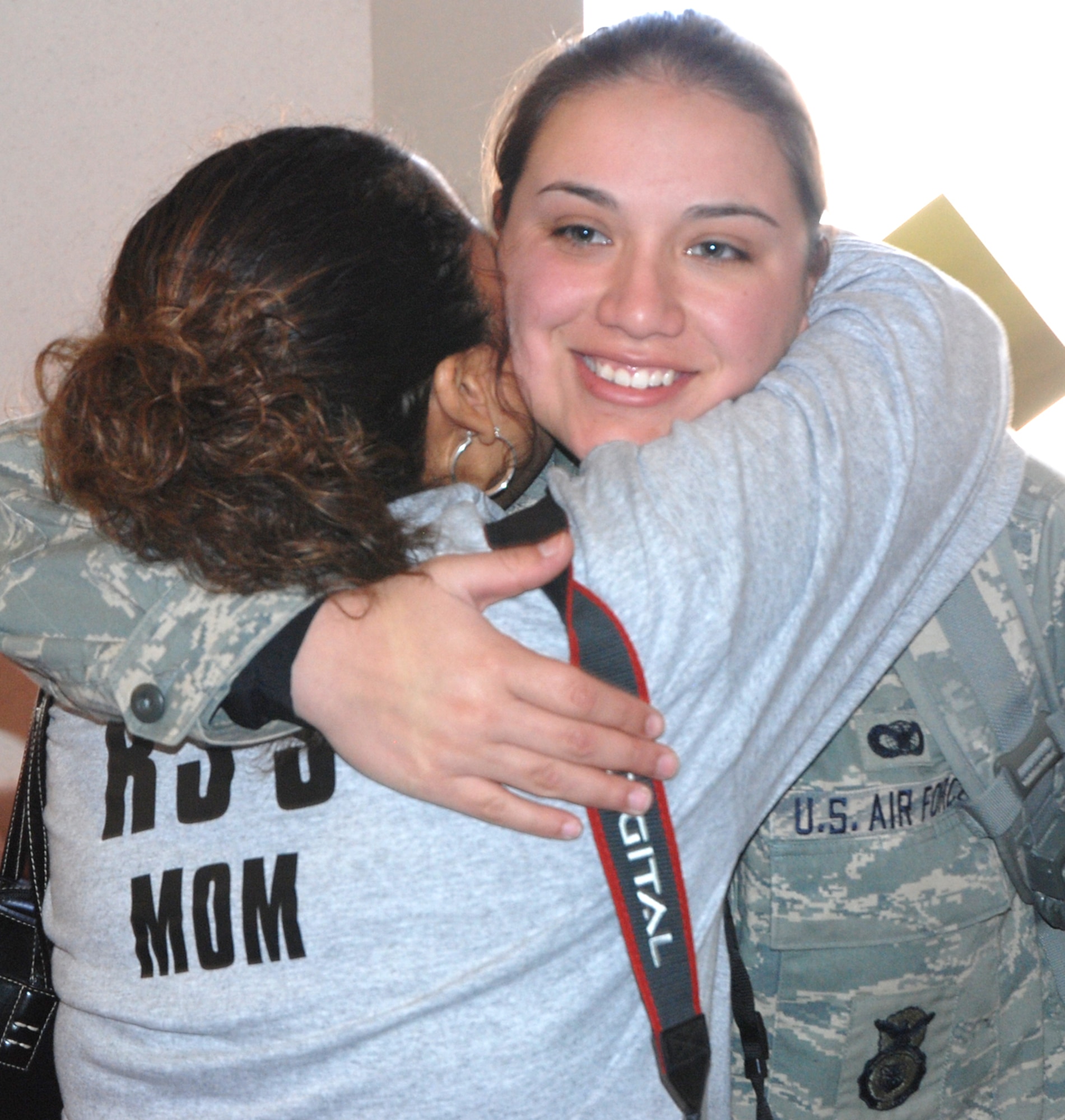 Airman 1st Class Miranda Catcher, 21st Security Forces Squadron, hugs her mother Sandra Kester at the Colorado Springs Airport Feb. 12 after returning from a deployment to Camp Bucca, Iraq. Airman Catcher re-deployed to Peterson with 10 other 21st SFS Airmen. The Airmen, deployed for six months, supported Operation Iraqi Freedom conducting ‘In Lieu Of” Army taskings, including detainee operations, off-base patrols and improvised-explosive device defense. Mrs. Kester traveled with her family from Stillwell, Okla., to see her daughter Airman Catcher return. (U.S. Air Force photo/Senior Airman Stephen Collier)
