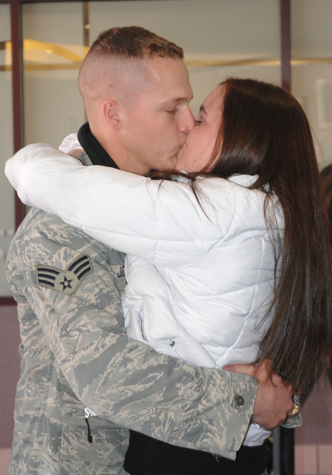 Senior Airman Mattison Johnson, 21st Security Forces Squadron, embraces his wife at the Colorado Springs Airport Feb. 12 after returning from a deployment to Camp Bucca, Iraq. Airman Mattison re-deployed to Peterson with 10 other 21st SFS Airmen. The Airmen, deployed for six months, supported Operation Iraqi Freedom conducting ‘In Lieu Of” Army taskings, including detainee operations, off-base patrols and improvised-explosive device defense. (U.S. Air Force photo/Senior Airman Stephen Collier)