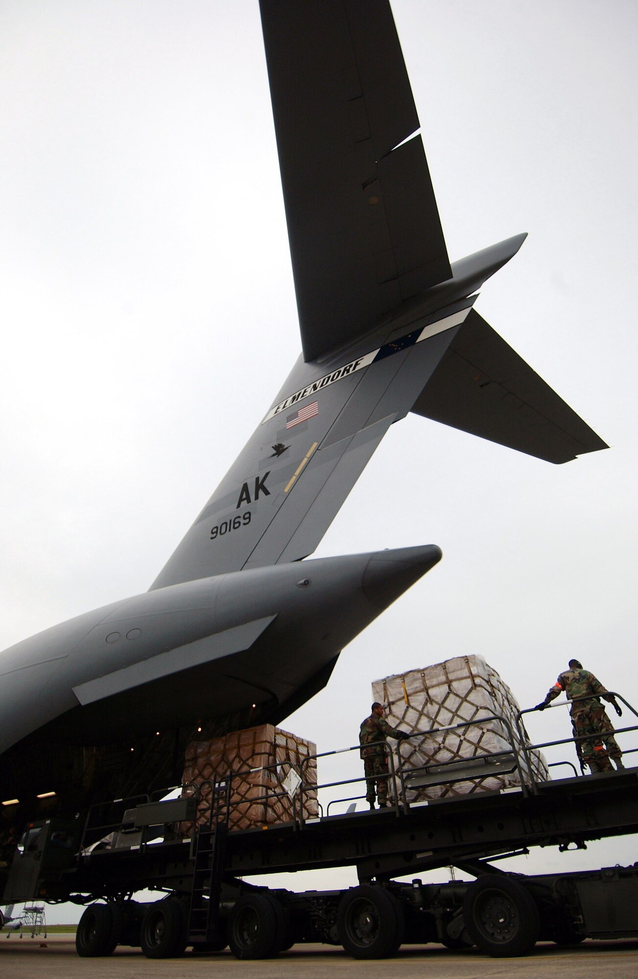 Airmen from the 733rd Air Mobility Squadron load cargo onto a C-17 Globemaster III from Elmendorf Air Force Base, Alaska Feb. 8 at Kadena Air Base, Japan. The 733rd AMS loaded medical supplies, food rations and cold weather gear onto this C-17 and another from Hickam Air Force Base, Hawaii, bound for China. Recently, 19 Chinese provinces experienced the most severe winter storms in 50 years, imposing severe hardships on millions of Chinese citizens. U.S. Pacific Command coordinated the delivery of the humanitarian supplies to People's Liberation Army at Shanghai International Airport, China. (U.S. Air Force photo/Tech. Sgt. Rey Ramon)