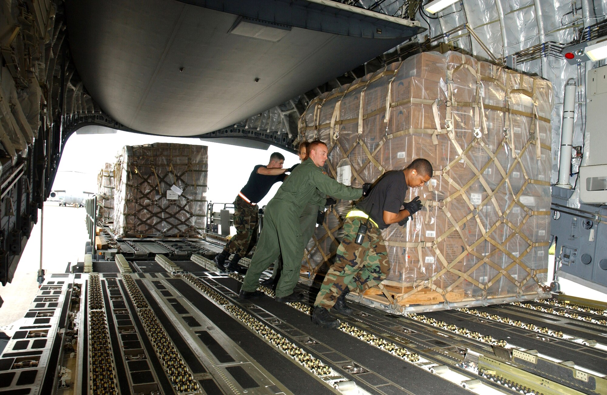Airmen from the 733rd Air Mobility Squadron at Kadena Air Base, Japan, and 15th Airlift Wing at Hickam Air Force Base, Hawaii, load food, cold weather gear and medical supplies onto a C-17 Globemaster III bound for China Feb. 8 at Kadena AB. Recently, 19 Chinese provinces experienced the most severe winter storms in 50 years, imposing severe hardships on millions of Chinese citizens. U.S. Pacific Command coordinated the delivery of the humanitarian supplies to People's Liberation Army at Shanghai International Airport, China. (U.S. Air Force photo/Senior Airman Jeremy McGuffin) 
