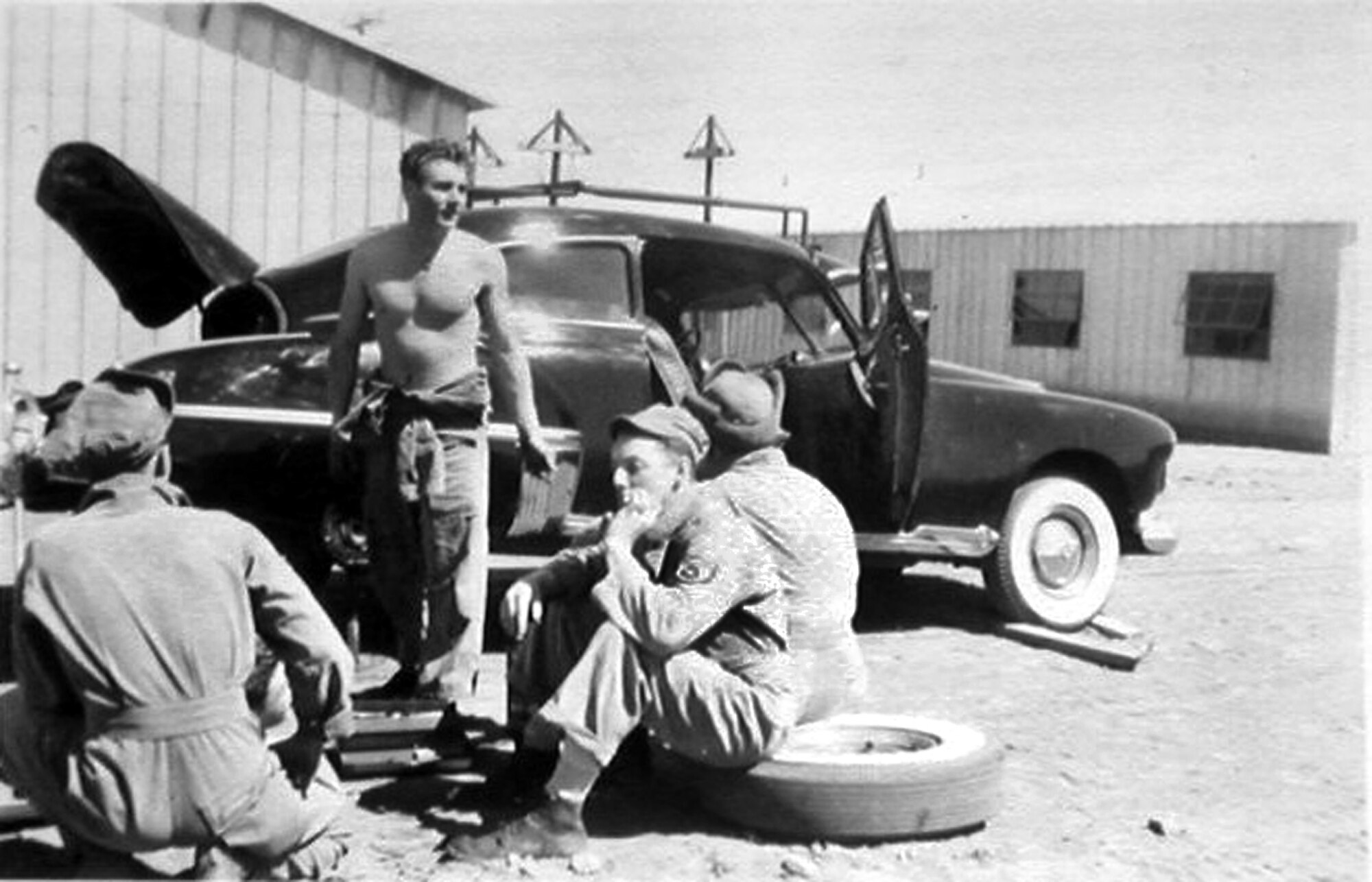 Airmen perform maintenance on a personally owned vehicle circa 1950's. (Photo courtesy of the Malmstrom Museum)