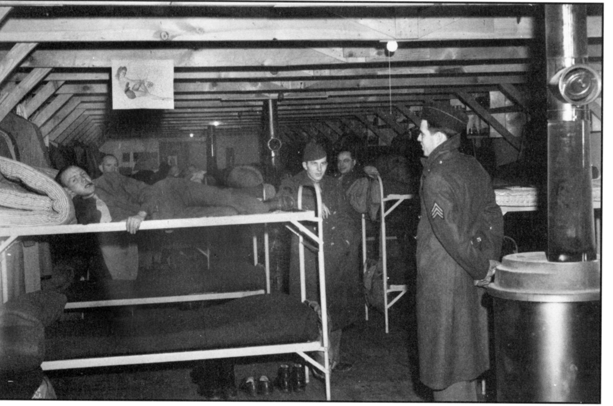 Airmen slept in barracks like these in the early 40's. Above the rack to the left is a photo of Betty Grable and in the foreground is a coke-burning stove. Each barracks contained three stoves. (Photo courtesy of the Malmstrom Museum)