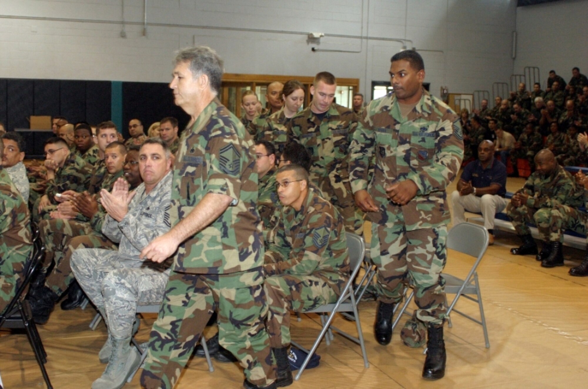 Reservists from the 482nd Maintenance Squadron Munitions Storage Area leave their seats and approach the front podium to receive the Outstanding Section of the Year award they shared with the 482nd MXS Aerospace Ground Equipment Flight during the second annual 482nd Maintenance Group Awards Ceremony on Feb. 10. Hundreds of people attended the ceremony that featured the appointment dedicated crew chiefs, announced the maintenance professionals of the year awards, and recognition of all maintainers and support personnel contributing to keeping the F-16 at top performance. (U.S. Air Force photo/Tech. Sgt. Paul Dean)