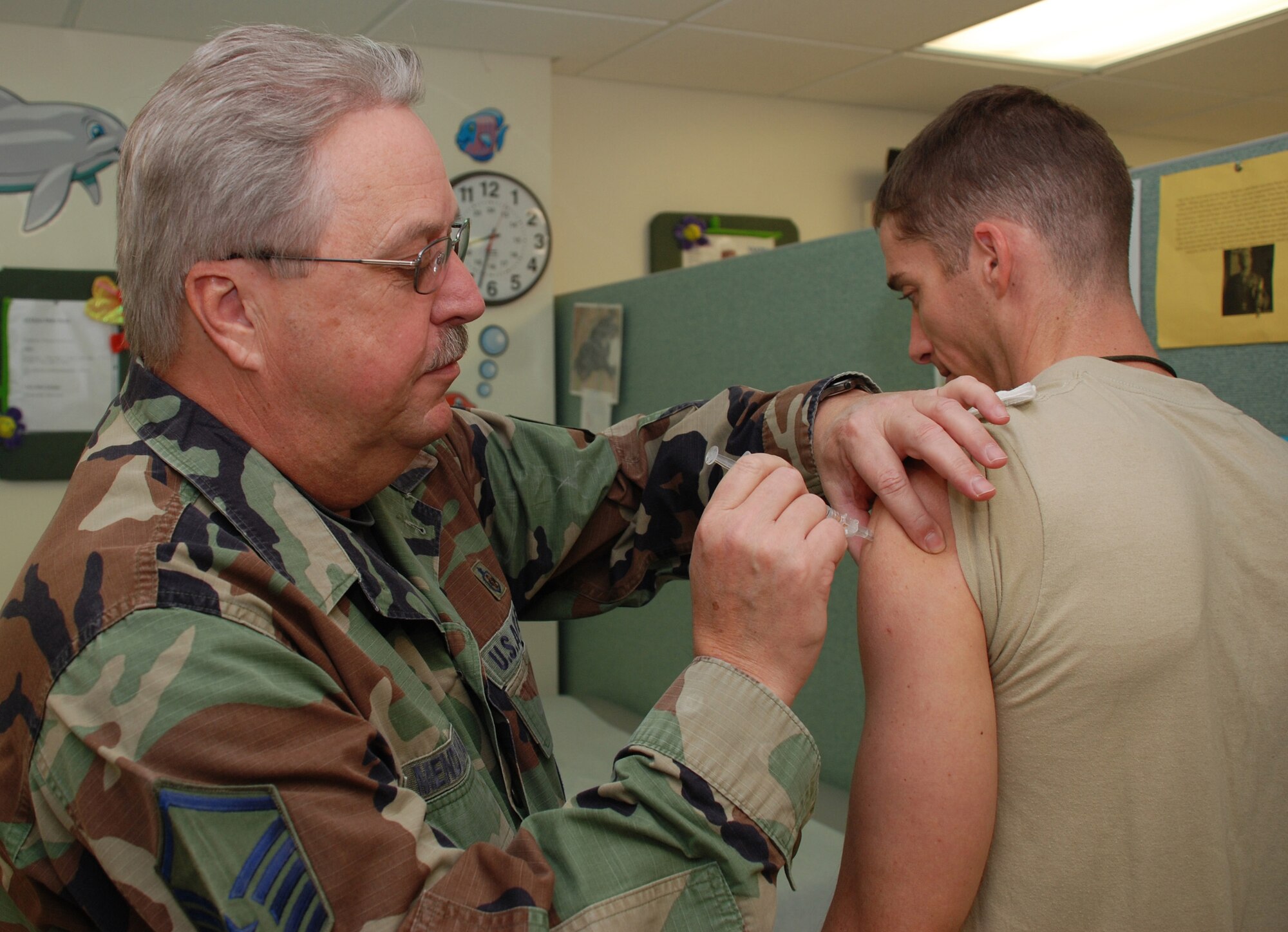 PATRICK AIR FORCE BASE, Fla. -- Senior Master Sgt. Thomas Mendenhall administers a vaccination to Army Capt. Scott Newman at the immunization clinic here. The immunization staff keeps servicemembers ready for deployment by maintaining shot currency for more than 1,200 wing personnel. (U.S. Air Force photo/Staff Sgt. Heather Kelly)