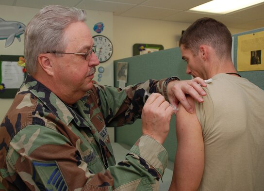 PATRICK AIR FORCE BASE, Fla. -- Senior Master Sgt. Thomas Mendenhall administers a vaccination to Army Capt. Scott Newman at the immunization clinic here. The immunization staff keeps servicemembers ready for deployment by maintaining shot currency for more than 1,200 wing personnel. (U.S. Air Force photo/Staff Sgt. Heather Kelly)