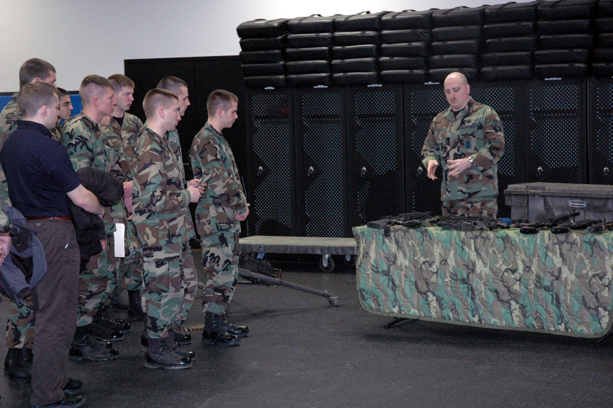 Tech. Sgt. Sean Heraty, from the U.S. Air Force Expeditionary Center's armory, shows ROTC cadets from the Rennsselear Polytechnic Institute from New York some of the weapons used for student training at the Center during the cadet's tour Feb. 8, 2008, at Fort Dix, N.J.  More than 25 cadets and staff toured the USAF EC to learn more about the school's expeditionary and mobility forces training for the Air Force.  (U.S. Air Force Photo/Tech./ Sgt. Scott T. Sturkol)