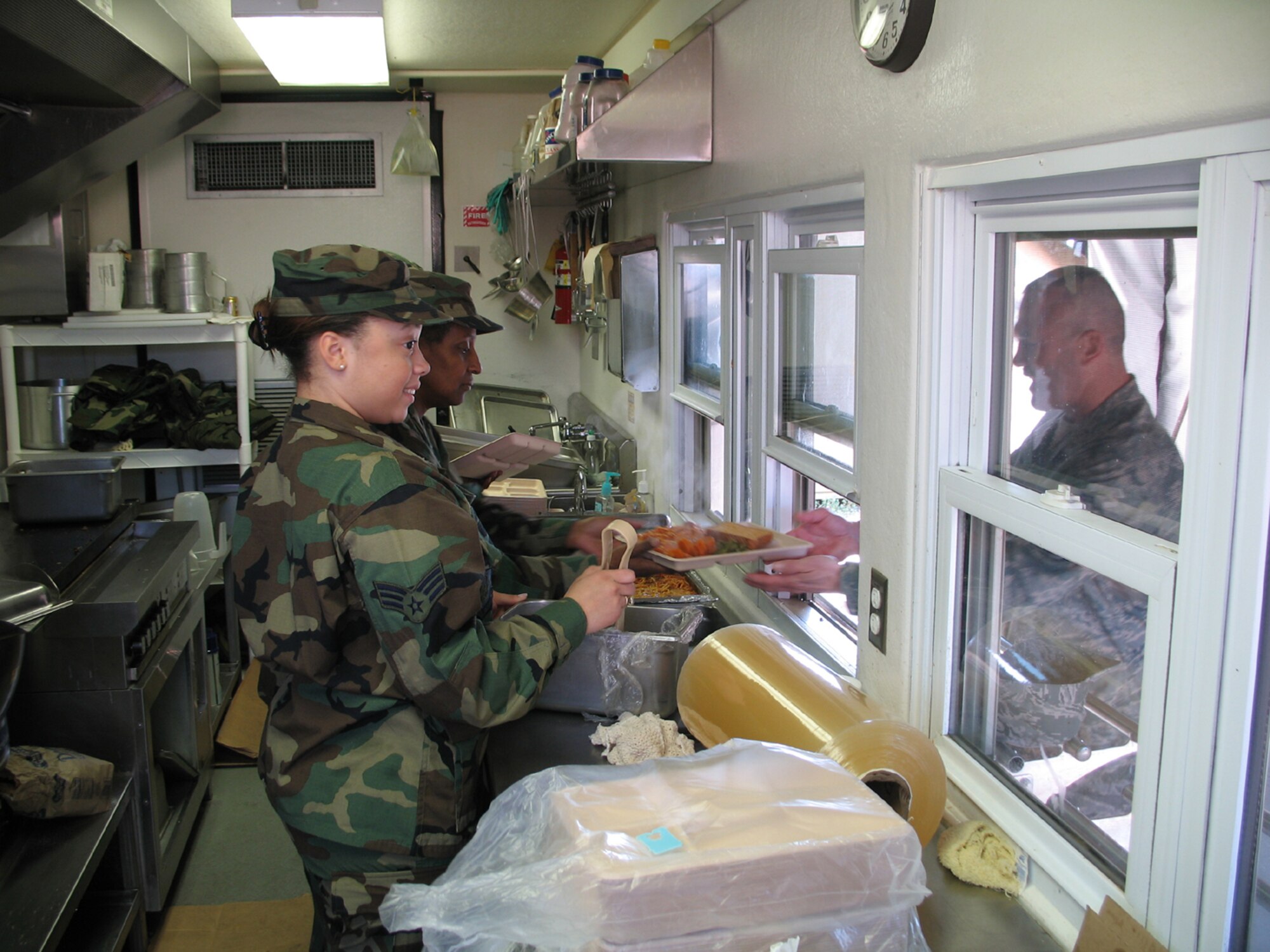 SEYMOUR JOHNSON AIR FORCE BASE, N.C.-- Members of the 916th Services Flight serve up a hot spaghetti lunch to members of the 916th Civil Engineer Squadron during the February unit training assembly. Reservists from both sections attended a four-day field training exercise in New London, N.C. Reservists worked in conjunction with National Guard members to train on everything from ability to survive and operate skills to mortuary affairs. The 916th Civil Engineer Squadron has conducted this mass training for the past three years.