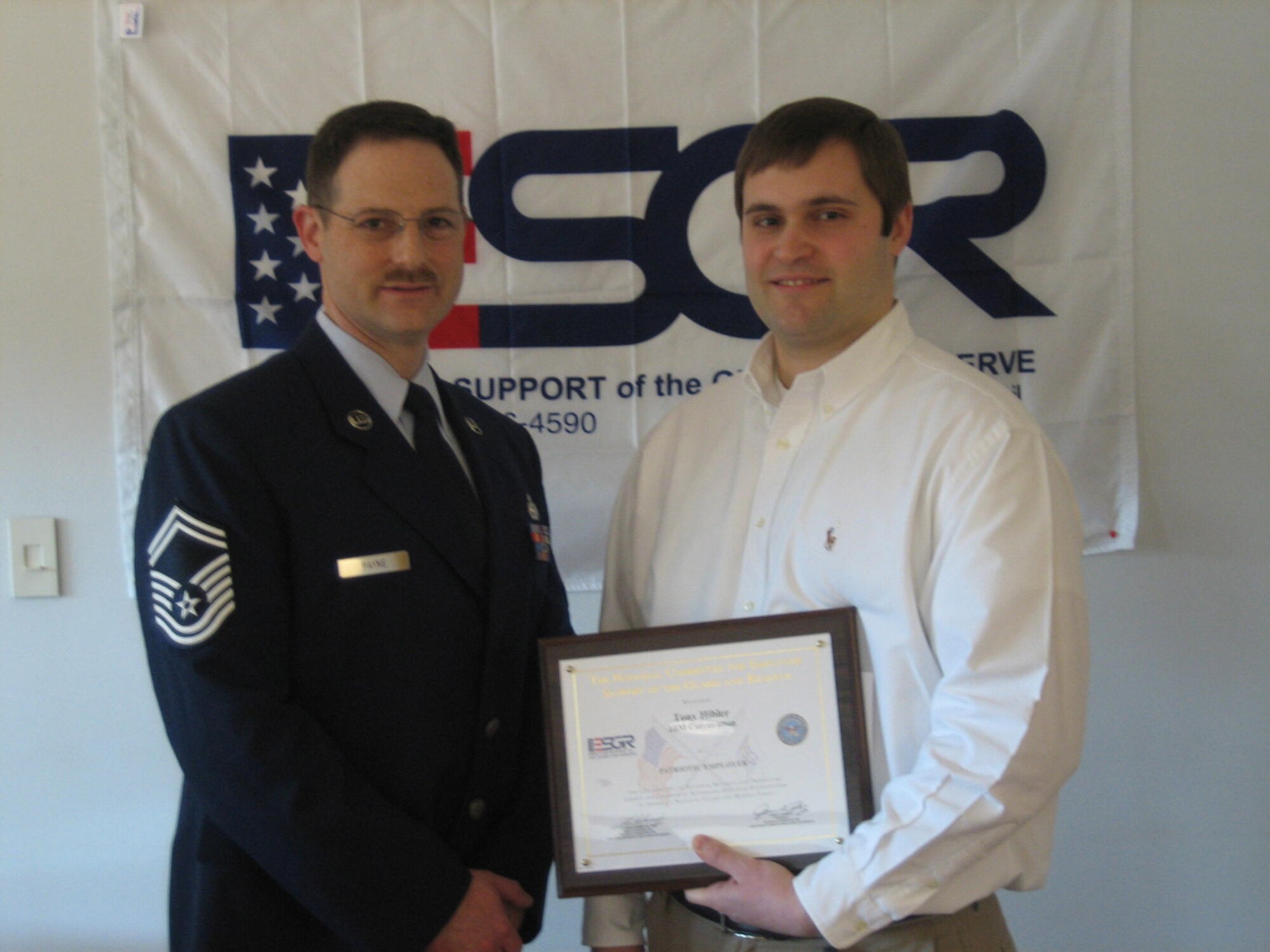 SEYMOUR JOHNSON AIR FORCE BASE, N.C.-- Senior Master Sgt. Bryan Payne (left), a member of the 916th Air Refueling Wing, presents his employer, Tony Hibler of IBM, with an Employer Support of Guard and Reserve Patriot Award. The award honors employers who give outstanding support to their National Guard and Reserve employees. Sgt. Payne works with the 916th Communications Squadron as a reservist and serves as a managing consultant with IBM. Sgt. Payne noted that not only did Mr. Hibler allow him to schedule his work around his drill weekends, but he also recognized the value of the training Sgt. Payne brought to the company from his Reserve commitment. For more information on the Patriot Award go to www.esgr.com