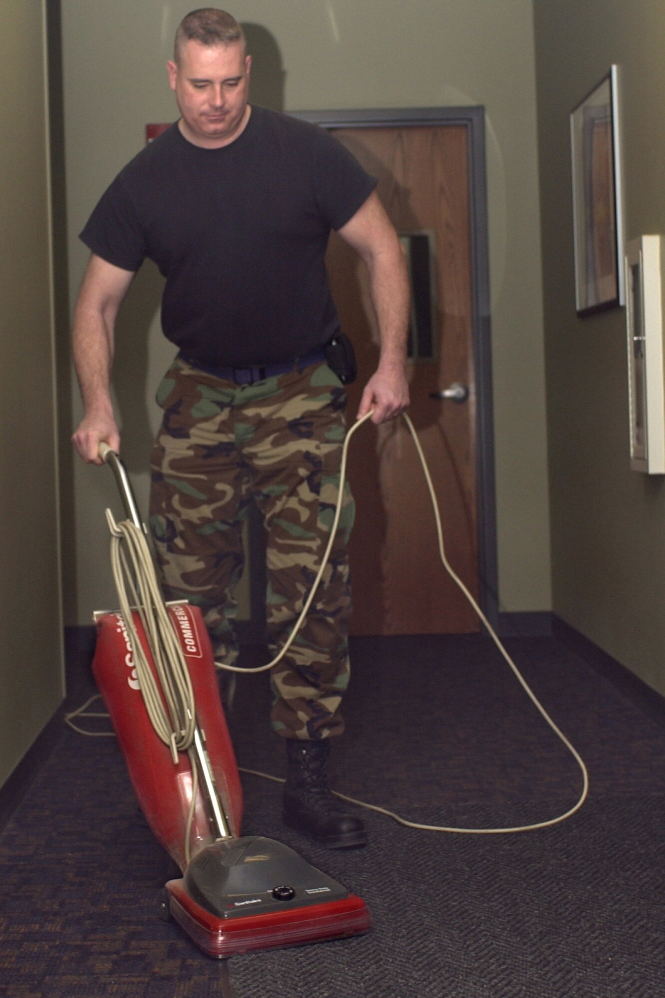 GRISSOM AIR RESERVE BASE, Ind., -- Staff Sgt. Robert O'Haver, an administration specialist with the 434th Communications Squadron, vacuums the floors of Bldg. 427.  "A clean home is a happy home," he said.  "Taking pride in your work environment will reflect in everything else you do." (Air Force photo/Senior Airman Ben Mota)