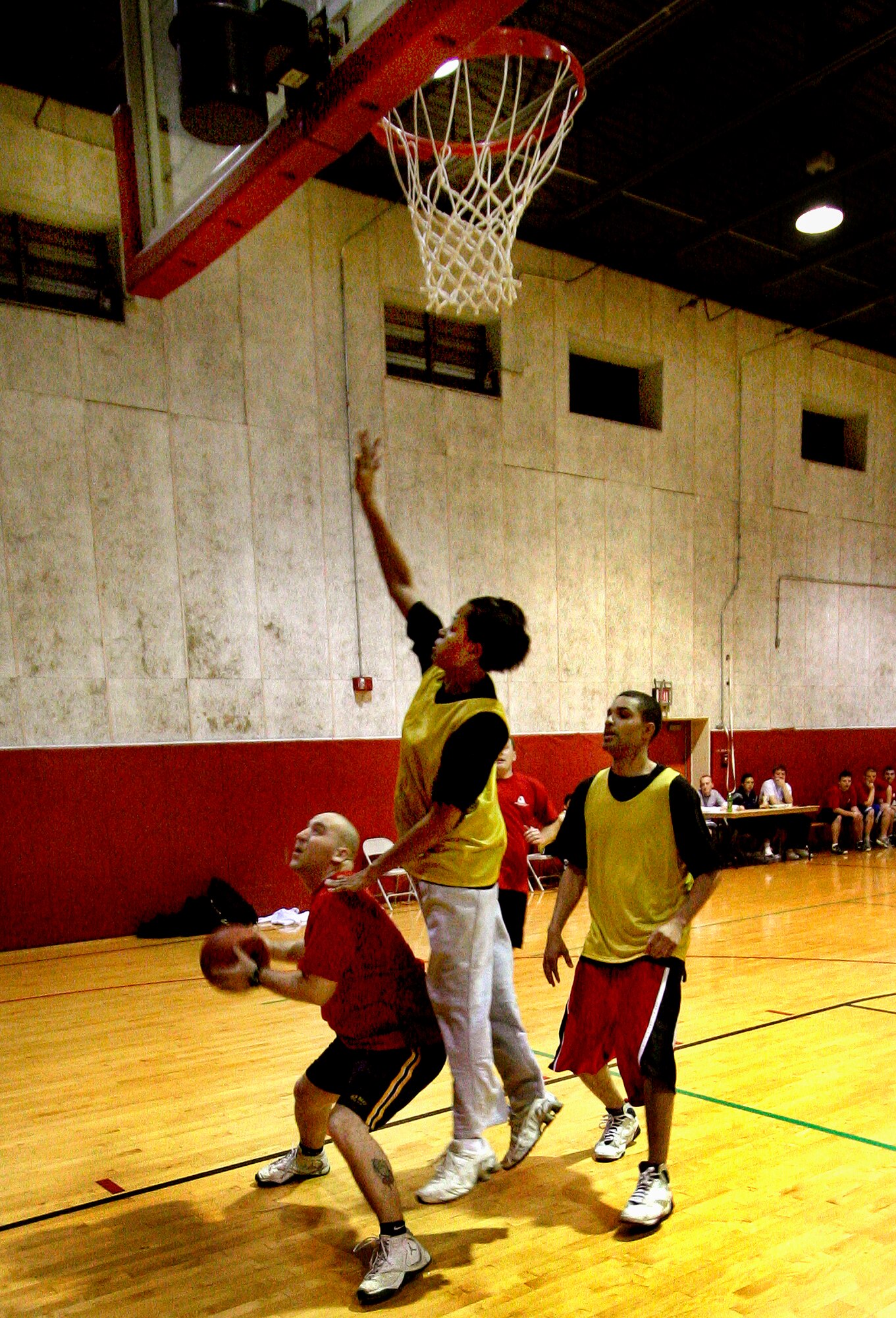 GRISSOM AIR RESERVE BASE, Ind., --  Tony Ayres, Department of Defense Police, attempts a lay-up against the 434th Logistics Readiness Squadron's Lydia Douglas and Gerard Merchant during second round action of the Grissom annual basketball tournament.  The cops handcuffed LRS 51-33. (U.S. Air Force Photo/Tech. Sgt. Patrick M. Kuminecz)

