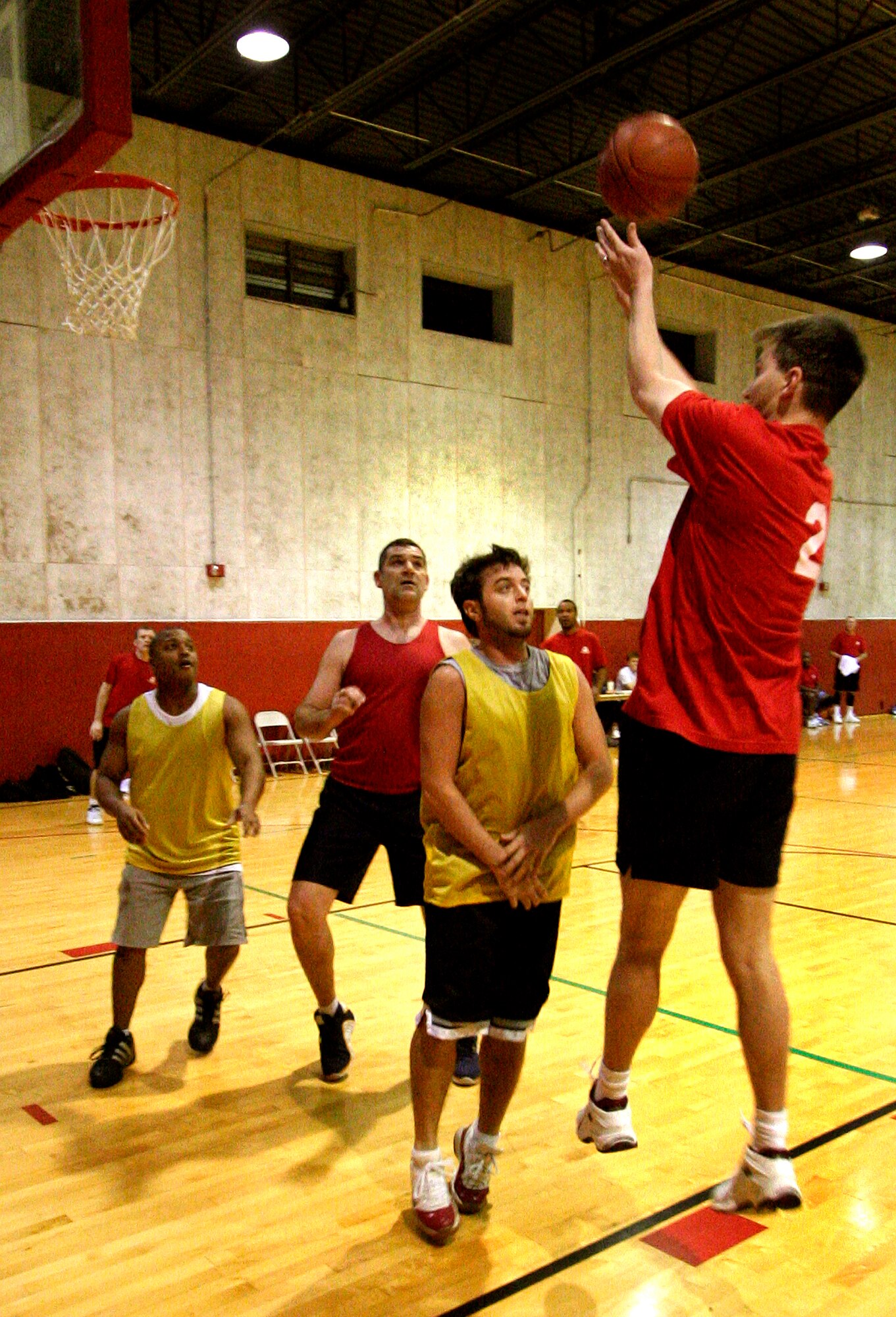 GRISSOM AIR RESERVE BASE, Ind.,  -- Ben Durr, Department of Defense Police, attempts a shot over two members of the 434th Logistics Readiness Squadron team as they position themselves for the rebound during Grissom's annual basketball tournament. The second round of the tournament was held during the February unit training assembly.  (U.S. Air Force Photo/Tech. Sgt. Patrick M. Kuminecz)

