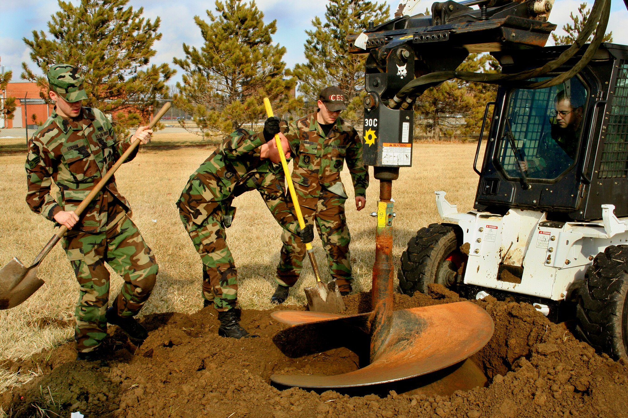 GRISSOM AIR RESERVE BASE, Ind., -- Senior Airmen Matt Crummel, Mark Stidham, Shawn Colazzi and Sam Siemons, 434th Civil Engineer Squadron,  excavate a hole that was used for the new base flag pole located just north of Bldg. 596. The new flag pole has been a popular addition to the base.  Projects to help improve Grissom ARB are just one of the many activities members of the 434th CES are involved in during monthly Unit Training Assemblies. (U.S. Air Force Photo/Tech. Sgt. Patrick Kuminecz)
