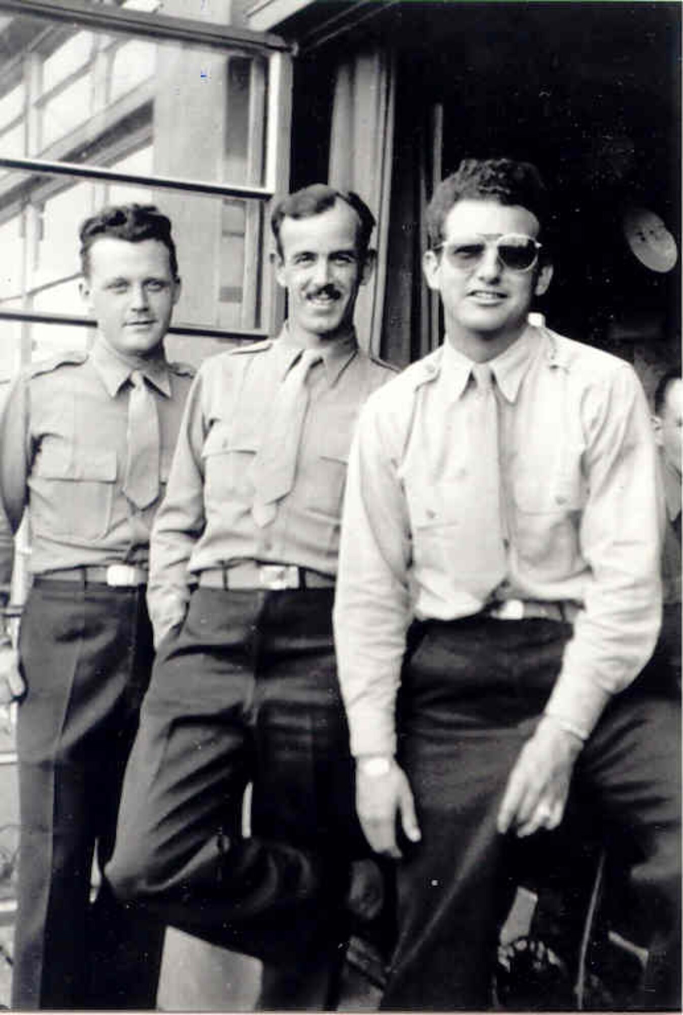 Captain Robert L. Johnson, U.S. Army Air Corps (on left in photo)  was on duty in what was then called Flying Control in the Molesworth Tower the night in 1944 when the hangar where B-17s Flying Fortresses were repaired was accidentally bombed by the Royal Air Force.  That same hangar now is temporary home to the Intelligence Fusion Centre in support of NATO.  (Photo courtesy 303rd Bomb Group Association and Mary Johnson Hemminger)