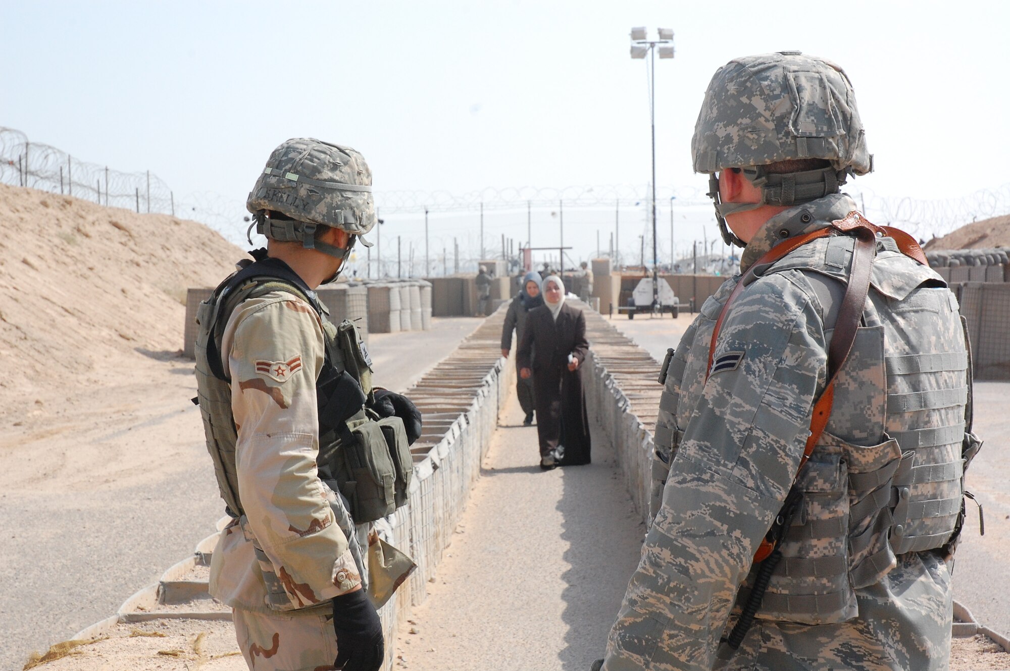 CAMP BUCCA, Iraq – Airman 1st Class Shane Kelly, left, and Airman 1st Class Russ Stiegemeier, both assigned to the 886th Expeditionary Security Forces Squadron, prepare to process Iraqis visiting family members detained in the Theater Internment Facility in Camp Bucca, Iraq, Feb 10, 2008.  Airmen deployed to the 886th ESFS operate the TIF’s vigorous visitation program which houses detainees determined to be a security threat against Iraqi citizens or coalition forces. More than 1,700 friends and family members visit the detainees each week. Airman Kelly is deployed from Hickam Air Force Base, Hawaii and Airman Stiegemeier is deployed from Malmstrom AFB, Mont. (U.S. Air Force Photo/Capt. Jason McCree)