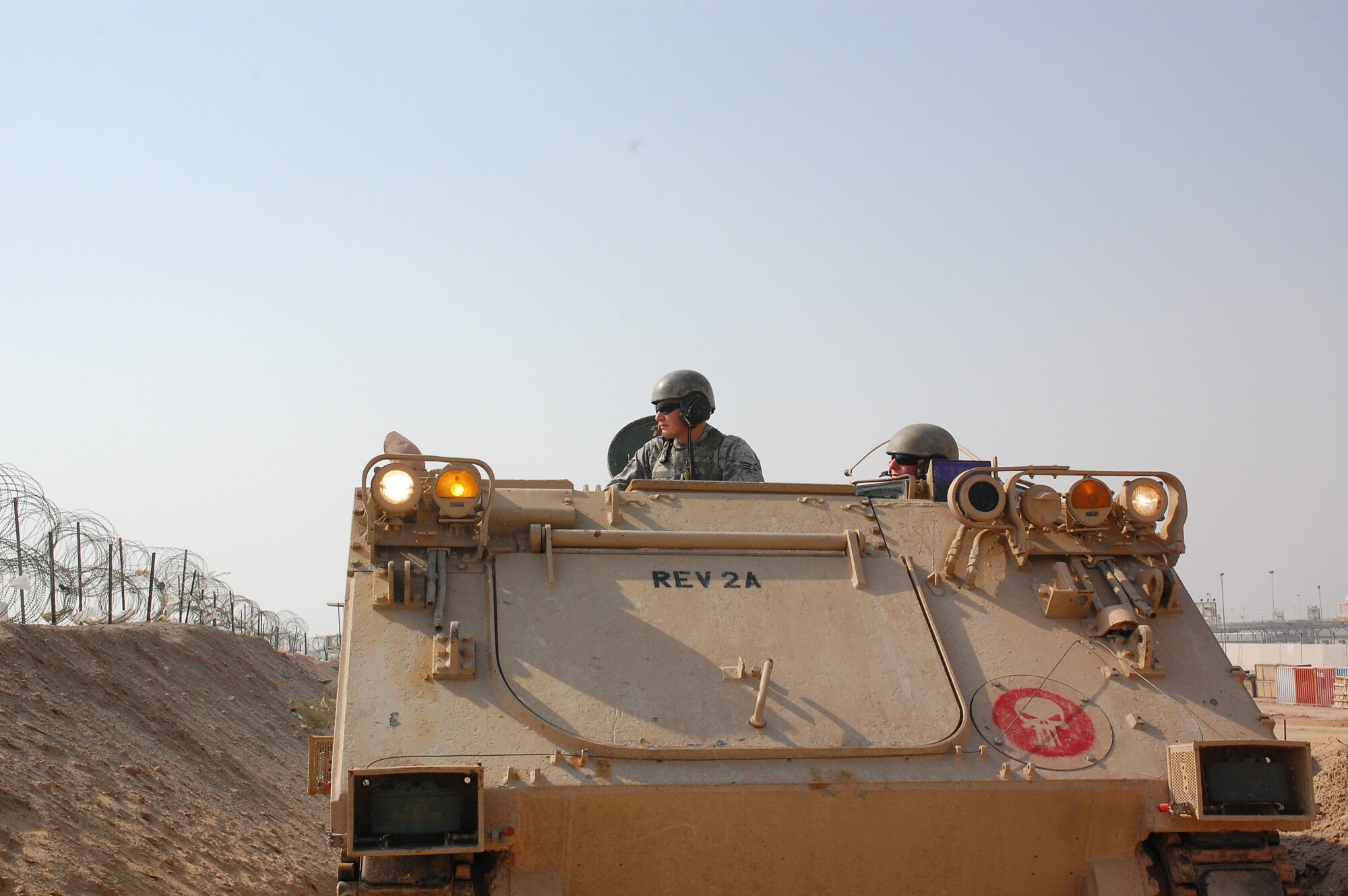 CAMP BUCCA, Iraq – Senior Airman Travis Hummel, left, and Airman 1st Class Adam Giebitz patrol in an M-113 Armored Personnel Carrier at the Theater Internment Facility in Camp Bucca, Iraq, Feb. 10, 2008. Airmen Hummel and Giebitz are deployed from Robins Air Force Base, Ga., and are assigned to the 886th Expeditionary Security Forces Squadron’s quick response force.  The QRF responds to issues within the TIF in which a show of force or escalation of force is required beyond the capabilities for the TIF’s guard force.  (U.S. Air Force Photo/Capt. Jason McCree)