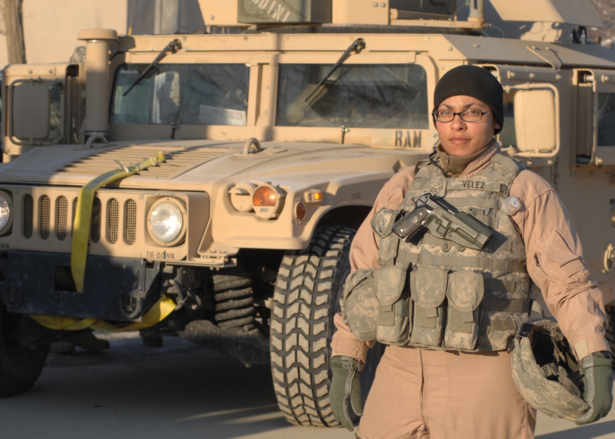 BAGRAM AIR BASE, Afghanistan - Senior Airman Vanessa Velez, a convoy driver with the Bagram Provincial Reconstruction Team, poses for a photo in front of the humvee she will be driving just before her next mission outside the wire here Feb. 10. Velez, who is a vehicle maintenance controller with the 6th Logistics Readiness Squadron at MacDill Air Force Base, Fla., has driven at least 120 convoys during her 365-day deployment in Afghanistan. (U.S. Air Force photo by Master Sgt. Demetrius Lester)