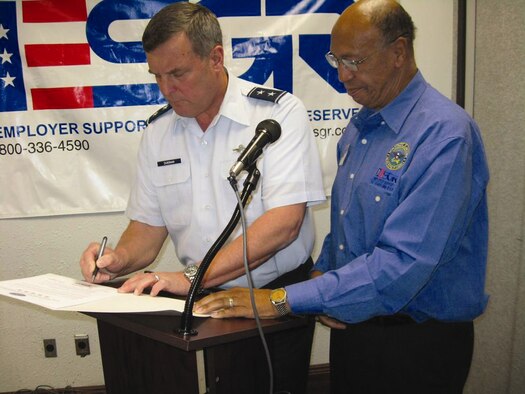 Major Gen. Robert E. Duignan, Fourth Air Force commander, signs a Department of Defense Statement of Support witnessed by Major Gen. (Ret.) Peter J. Gravett, Chairman of the California Committee.  (U.S. Air Force photo by Blanche Gravett)