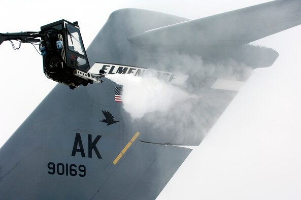 Members of the 703rd Aircraft Maintanance Squadron de-ice a C-17 Globemaster III loadmaster from the 517th Airlift Squadron before a training mission. The training mission included dropping Army Airborne Soldiers from Fort Richardson, Alaska, and conducting air drops of training bundles that simulate the Soldier's equipment. (U.S. Air Force photo/Master Sgt. Keith Brown)