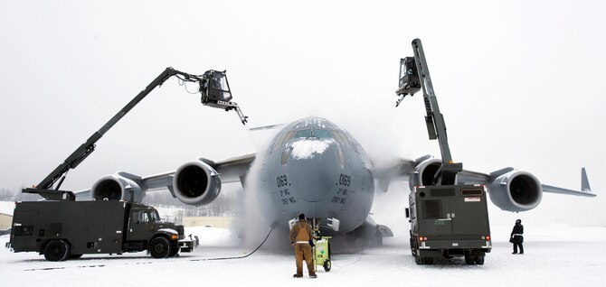 Members of the 703rd Aircraft Maintenance Squadron de-ice a C-17 Globemaster III from the 517th Airlift Squadron before a training mission. Heavy snow and weeks of sub-zero temperatures require extra effort from maintenance crews to keep the aircraft clear of ice and snow. The training mission included dropping Army Airborne Soldiers from Fort Richardson, Alaska, and conducting air drops of training bundles that simulate the Soldier's equipment. (U.S. Air Force photo/Master Sgt. Keith Brown) 
