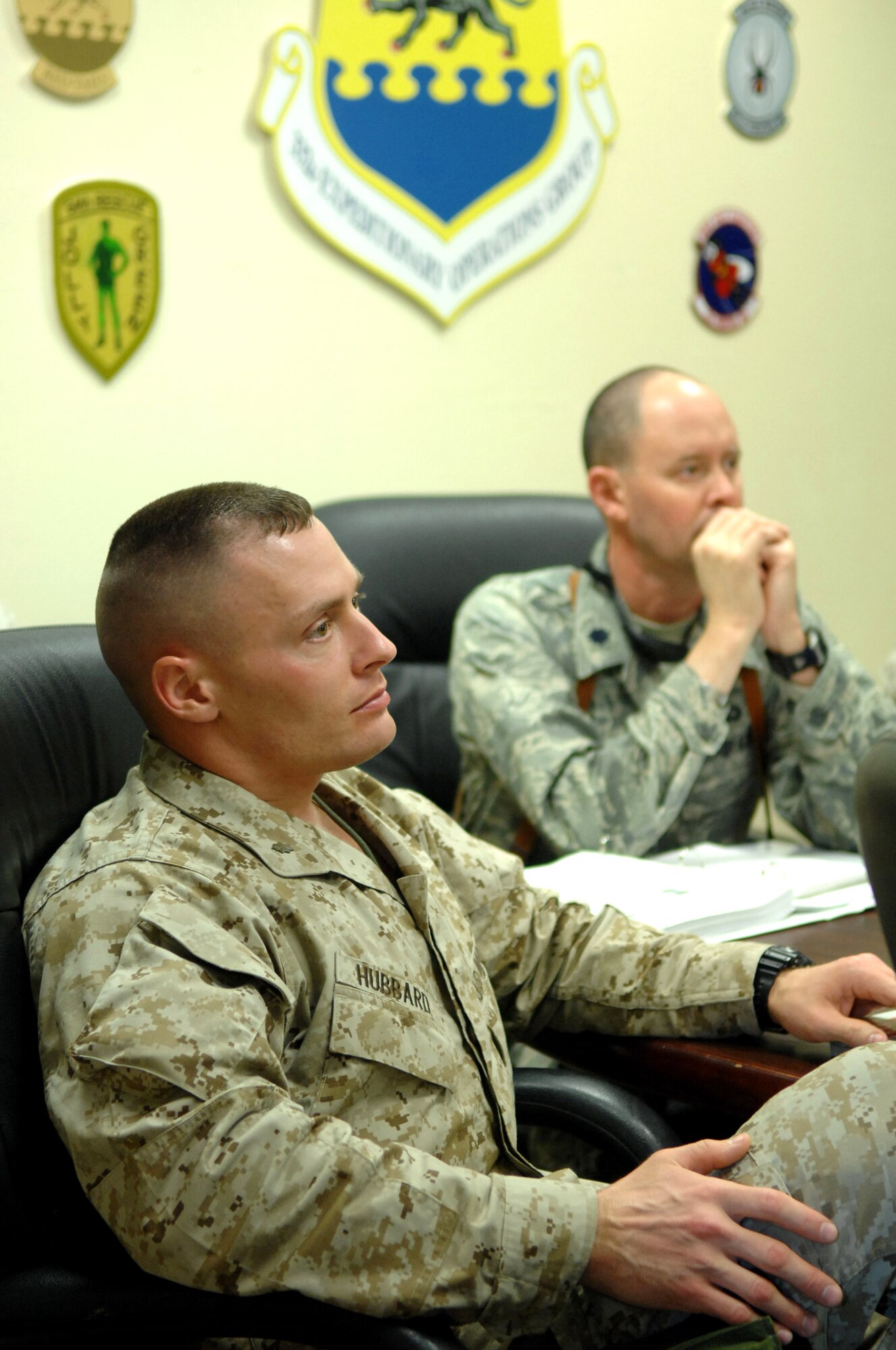 Lt. Col. Robert Ricker and Maj. Robert Hubbard listen to briefings about the importance of working together with sister service units to coordinate joint utilization of airspace here, Feb. 10. Colonel Ricker is the 332nd Expeditionary Operations Support Squadron airfield operations flight commander. Major Hubbard is the Direct Air Support Center operations chief. (U.S. Air Force photo/Senior Airman Julianne Showalter)