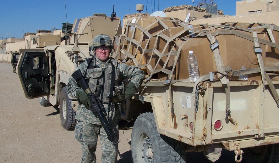 AN-NAJAF, Iraq -- Air Force Maj. Chris Gay poses with the 60 boxes of clothing to be handed out to Iraqi children at the Al-Manathera Internally Displaced Persons Camp near the city of Al-Najaf during a mission Feb. 2.  The major’s family, friends and co-workers living in three states collected more than 1,300 pounds of clothing and shoes to help hundreds of children at the camp.  The camp is the largest of eight scattered across Iraqi and houses more than 2,500 Iraqis, including 205 school-age children.  These families fled their homes following years of sectarian and terrorist violence.  The major, a division chief with the 507th Aircraft Sustainment Squadron at Hill Air Force Base, Utah, is currently deployed with a U.S. Army unit based in Baghdad.  U.S. Army photo