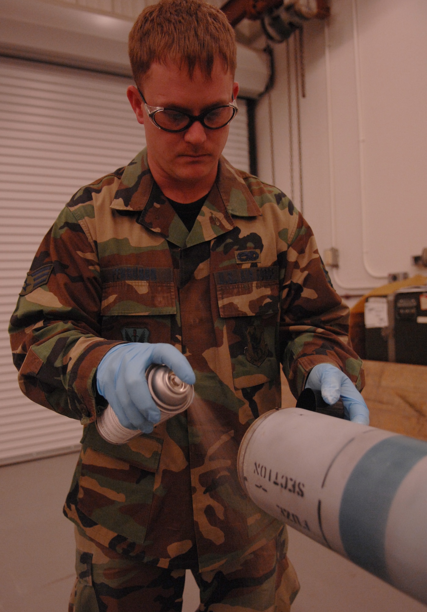 MOODY AIR FORCE BASE, Ga. -- Senior Airman William Ferguson, works on the missile body of an AIM-9 Sidewinder air-to-air missile Feb. 13 here. The AIM-9 missile is used on A-10 Thunderbolt II aircraft. This model is an inert variant used for training with a live seeker head. (U.S. Air Force photo by Airman 1st Class Gina Chiaverotti)
