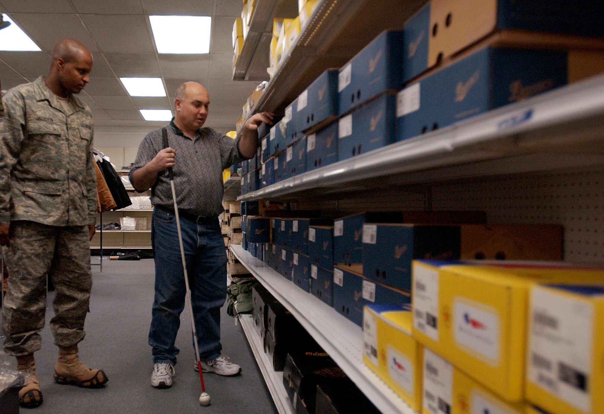 EIELSON AIR FORCE, Alaska--Helping customers with selecting the correct winter and deployment gear is a part of Mr. Mike Nafploitius's job as he assists Staff Sgt. Damon Jackson, the Unit Deployment Manager for the 354th Logistic Readiness Squadron with selecting the correct boots Staff Sgt. Jackson needs for deployment.  Mr. Nafploitius has been employed at the Individual Equipment Issue store at Eielson AFB since 2001 helping customers with clothing issue, stocking the clothing room and storing shipments in the stockroom.

(U.S Air Force photo by: Staff Sgt. Eric T. Sheler)
