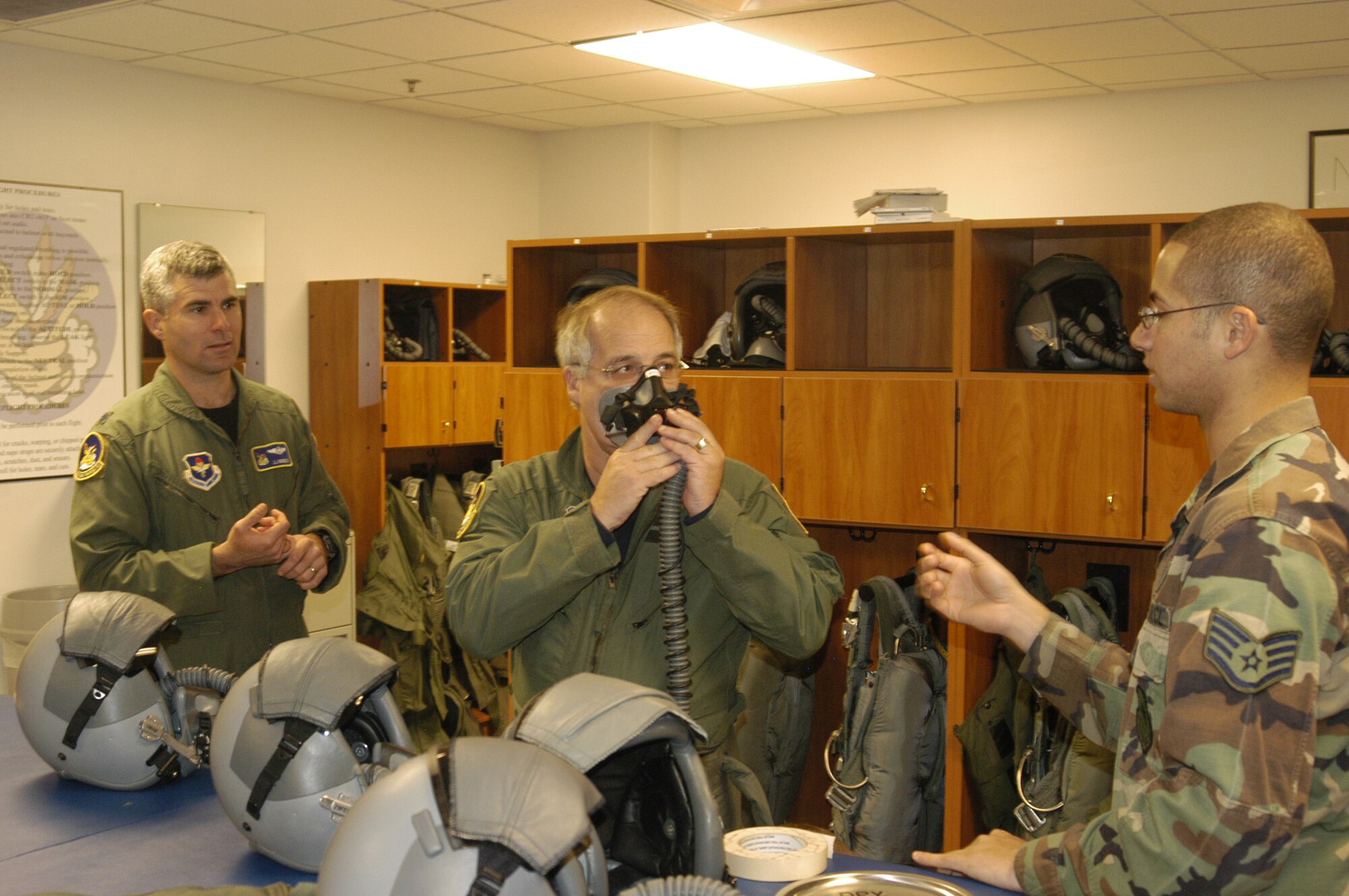 Staff Sgt. James Chase, 50th Flying Training Squadron life support, right, and Lt. Col. J.J. Menozzi, 50th FTS commander, help John Correnti, CEO and president of SeverCorr, prepare for his orientation flight in a T-38 Talon Feb. 12 at Columbus Air Force Base.