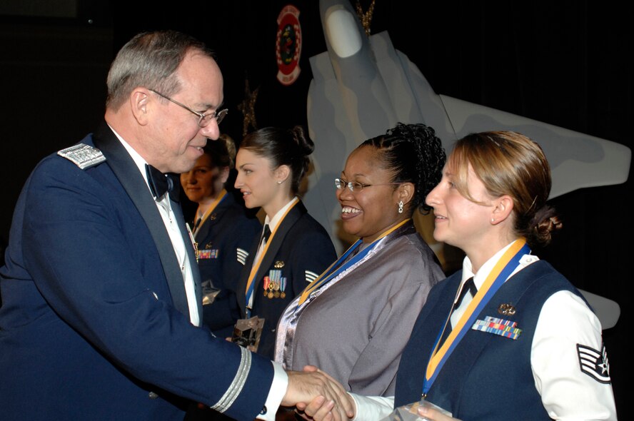 Lt. Gen. David Deptula, Deputy Chief of Staff for Intelligence, Surveillance and Reconnaissance Headquarters U.S. Air Force and guest speaker for the 33d Fighter Wing Annual Awards, congratulates Tech. Sgt. Jodi Trombetti, wife of Master Sgt. Steven Zellers, 728th Air Control Squadron first sergeant who won First Sergeant of the Year for 2007. Sergeant Trombetti accepted the award on behalf of her husband who is currently deployed in support of Operation Iraqi Freedom. (U.S. Air Force Photo)