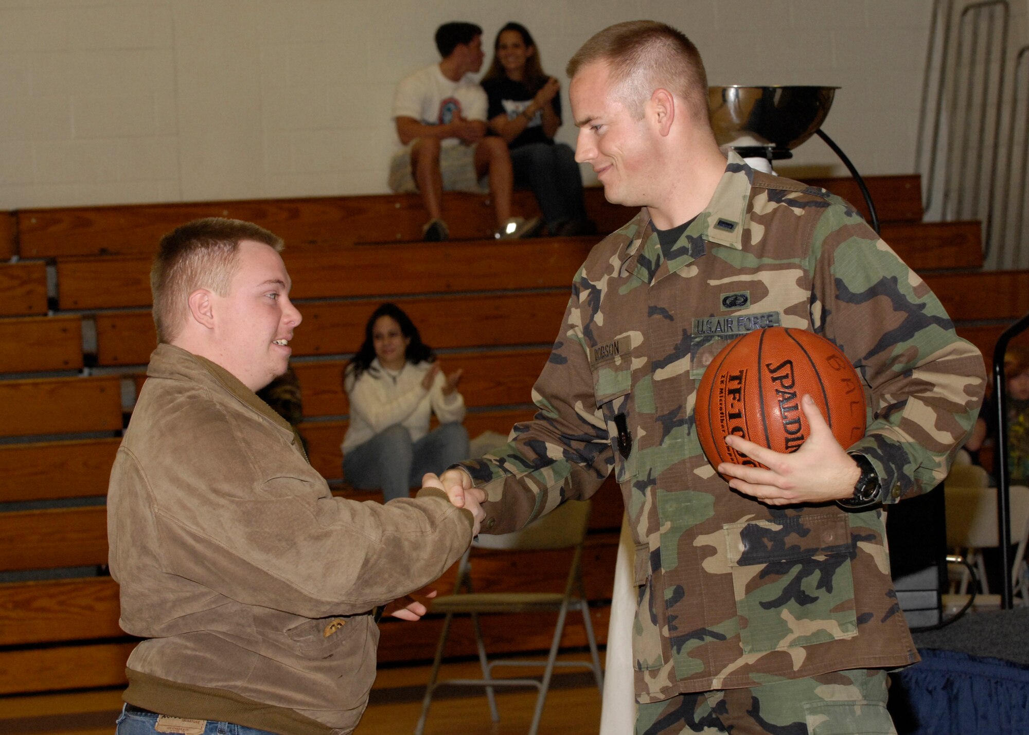 EGLIN AIR FORCE BASE, Fla. -- First Lt. Geoffrey Dobson, Company Grade Officer Council porject officer, shakes hands with Jeffrey Woods during the opening ceremonies of the 2008 Northwest Florida Sectional basketball tournament here Feb. 10. More than 350 athletes and coaches from Okaloosa, Walton, Jackson, Gadsden, Leon, Hamilton, Columbia, Escambia and Taylor counties participated in the sectional tournament. (U.S. Air Force photo by Gregg Murry)