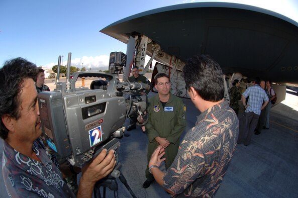 HICKAM AIR FORCE BASE, Hawaii-- Maj. Aaron "Pepe" Pepkowitz, B-2 liaison for 13th Air Force, provides comments to more than seven media representatives during a B-2 media event Feb. 12. The 393rd Expeditionary Bomb Squadron, stationed at Whiteman Air Force Base, Mo., is currently wrapping up it's deployment as a continuous bomber presence at Andersen Air Force Base, Guam. The B-2's low observability provides greater freedom of maneuver whle high altitiude flight increases its range and provides a better field of view for the aircraft's sensors. (U.S. Air Force photo by Vanessa M. Perez)