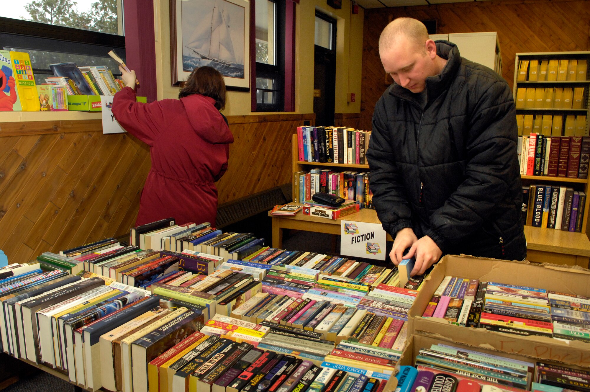 HANSCOM AFB, Mass. – Staff Sgt. Michael Foss, 66th Comptroller Squadron looks through the stacks of books on display at the Base Library’s used book sale on Feb. 13. Proceeds from the book sale will be used to purchase supplies and prizes for the Library’s 2008 Summer Reading Program.  (U.S. Air Force photo by Mark Wyatt)