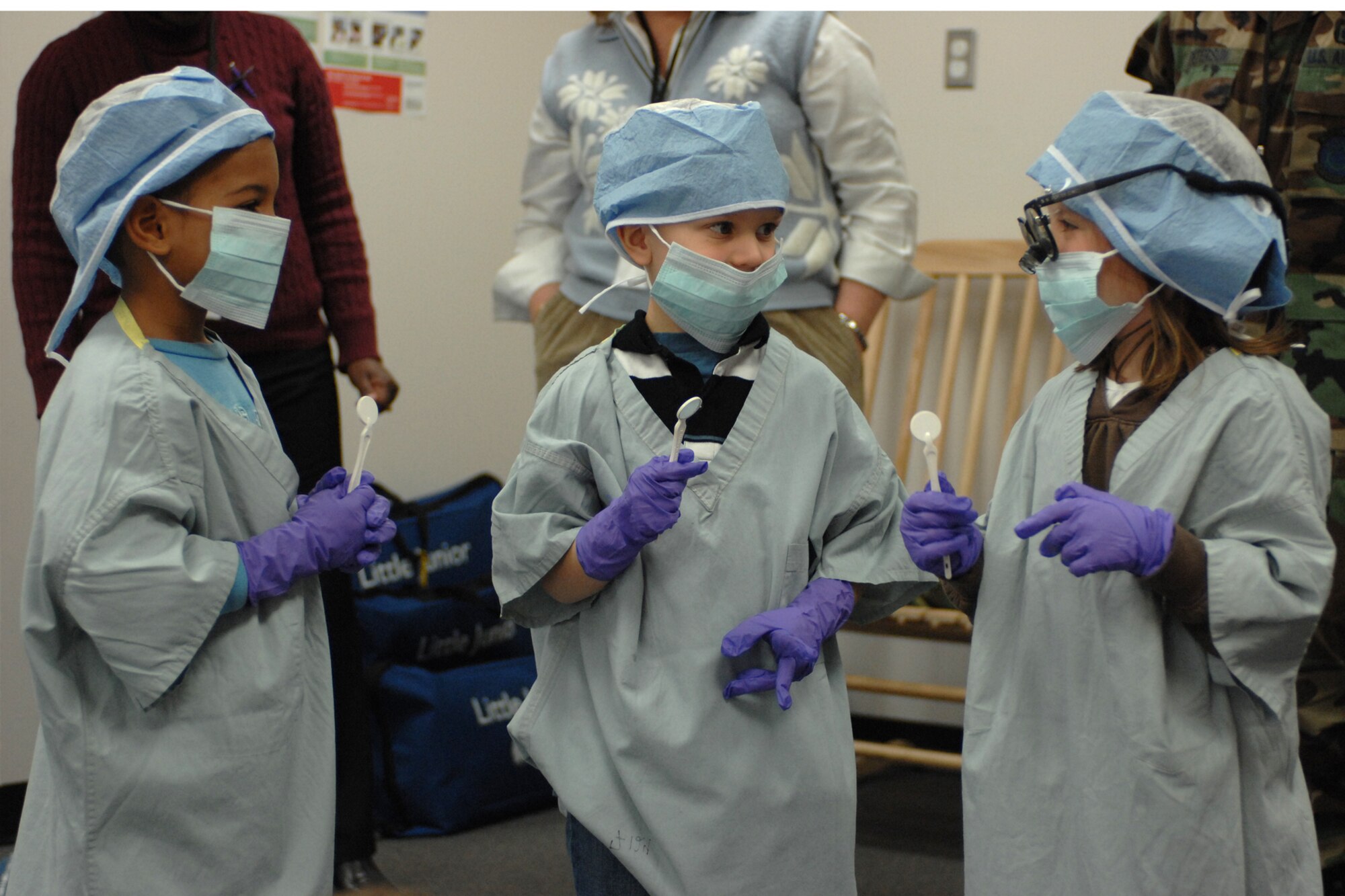 LANGLEY AIR FORCE BASE, Va. -- Children dressed up as dentists admire their new look during a health and hygiene presentation Feb. 12 given by 1st Dental Squadron Airmen at the Russ Child Development Center here. The class stressed teeth and mouth cleanliness as well as good eating habits. February is National Children's Dental Health Month. (U.S. Air Force photo/Airman Rebecca Montez)