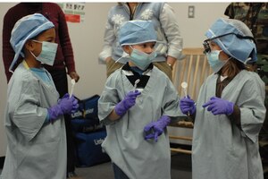 LANGLEY AIR FORCE BASE, Va. -- Children dressed up as dentists admire their new look during a health and hygiene presentation Feb. 12 given by 1st Dental Squadron Airmen at the Russ Child Development Center here. The class stressed teeth and mouth cleanliness as well as good eating habits. February is National Children's Dental Health Month. (U.S. Air Force photo/Airman Rebecca Montez)