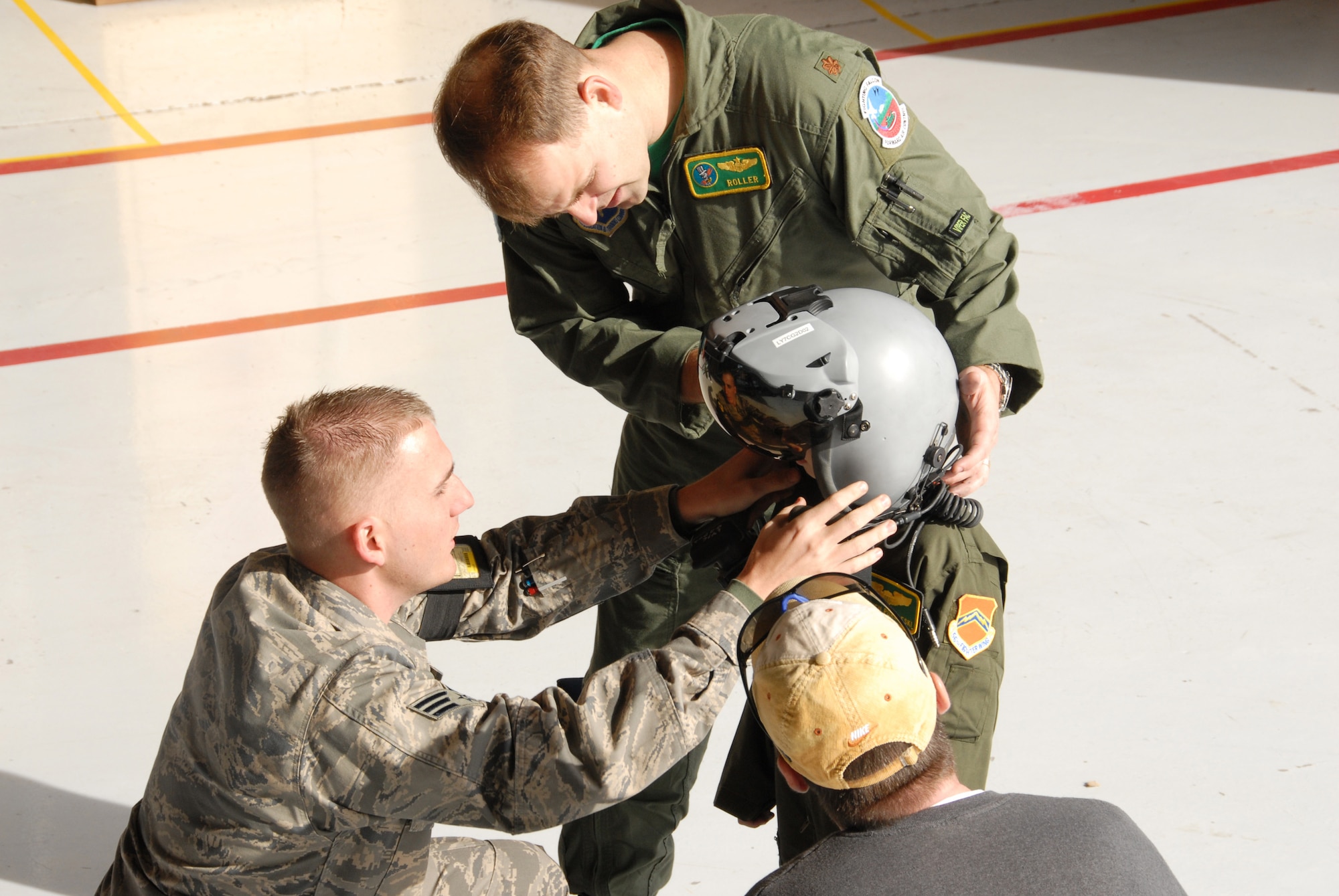 Stephen Purulesk, 6, recieves a helmut fitting before climbing into an F-16 durring his pilot for a day adventure at Luke on Feb. 8. (photo by Airman 1st Class David Bulkley)