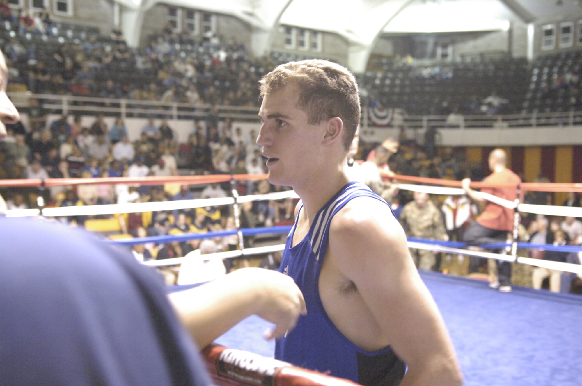 Airman 1st Class David Russell, 43rd Logistics Readiness Squadron, talks to his coach following a bout in the finals of the 2008 Armed Forces Boxing Championship. Although Airman Russell lost the bout to a Marine Corps boxer, he has only been boxing for a little more than a year and earned a spot on the Air Force Boxing Team at 141 pounds in January. (U.S. Air Force photo by Staff Sgt. Jon LaDue)