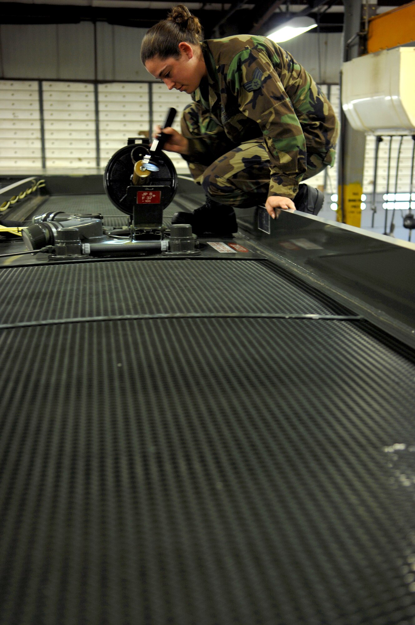 MOODY AIR FORCE BASE, Ga. – Senior Airman Shayna Jacoby, 23rd Logistics Readiness Squadron refueling maintenance technician, inspects a fuel truck man hole here Feb 6.  Inspections are done daily to prevent spills and accidents.  (U.S. Air Force photo by Senior Airman Angelita Lawrence)